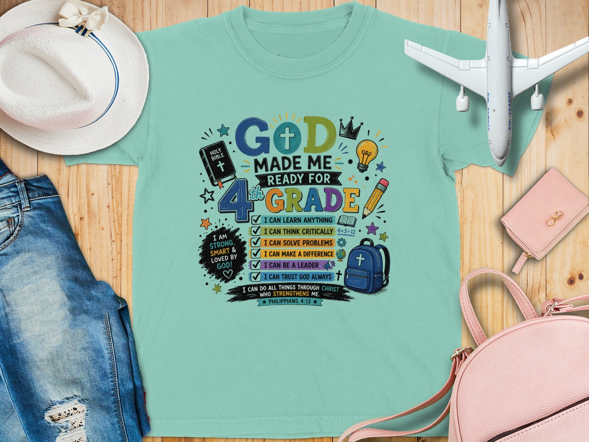 "God Made Me Ready for 4th Grade" graphic tee with biblical verses and school icons.