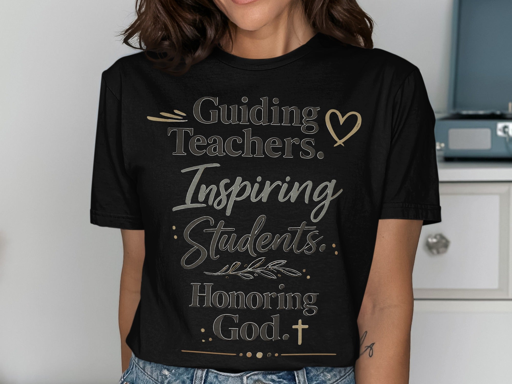 Black t-shirt with gold text: "Guiding Teachers. Inspiring Students. Honoring God."
