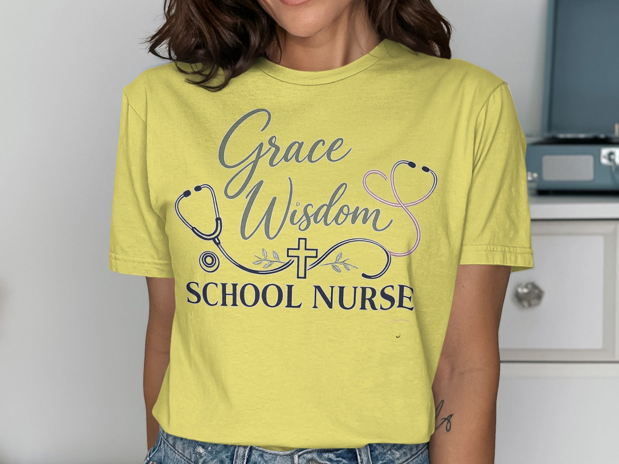 Yellow t-shirt with "Grace Wisdom School Nurse" and a stethoscope.
