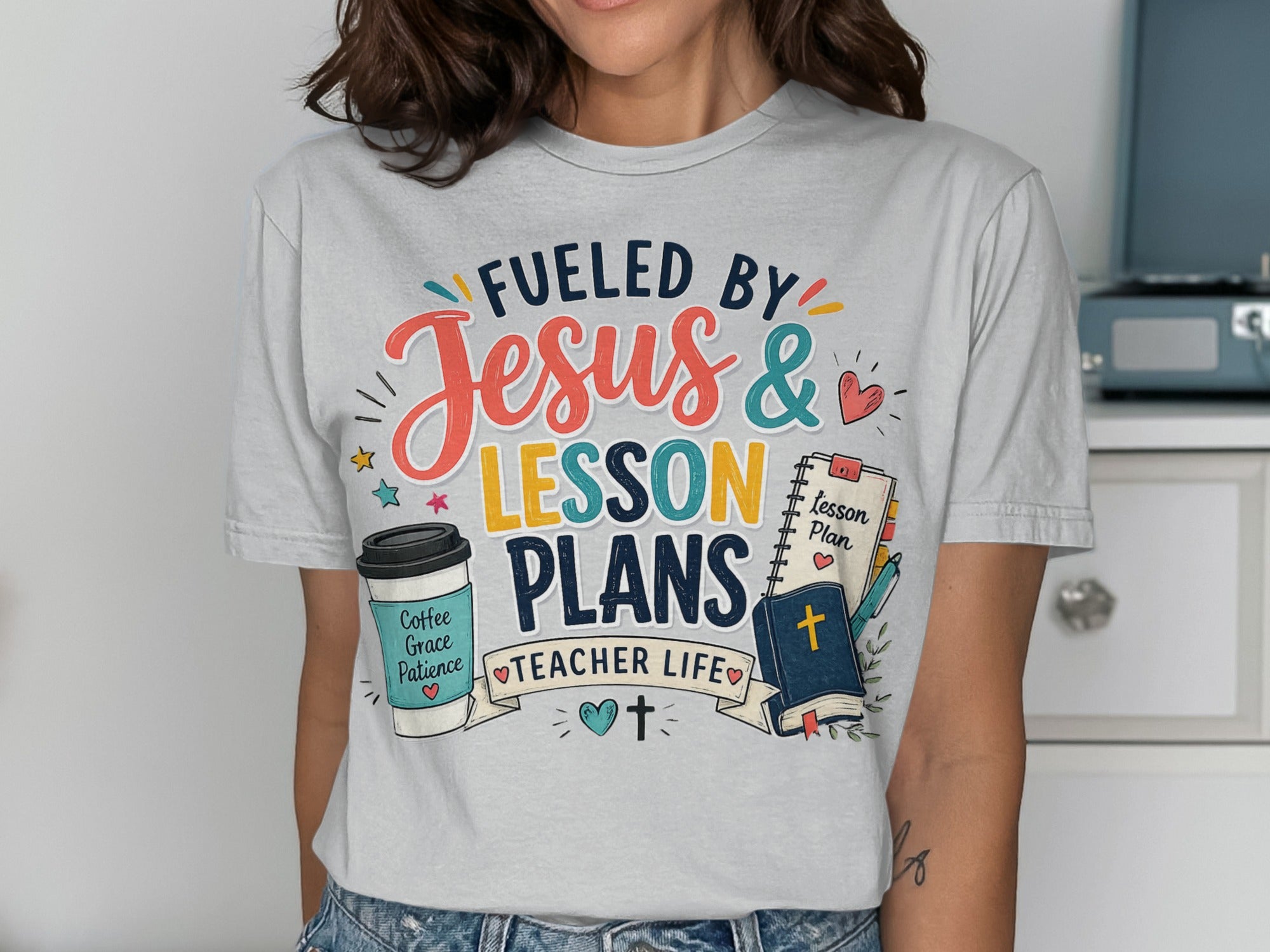 T-shirt with "Fueled by Jesus & Lesson Plans" and teacher-themed icons.