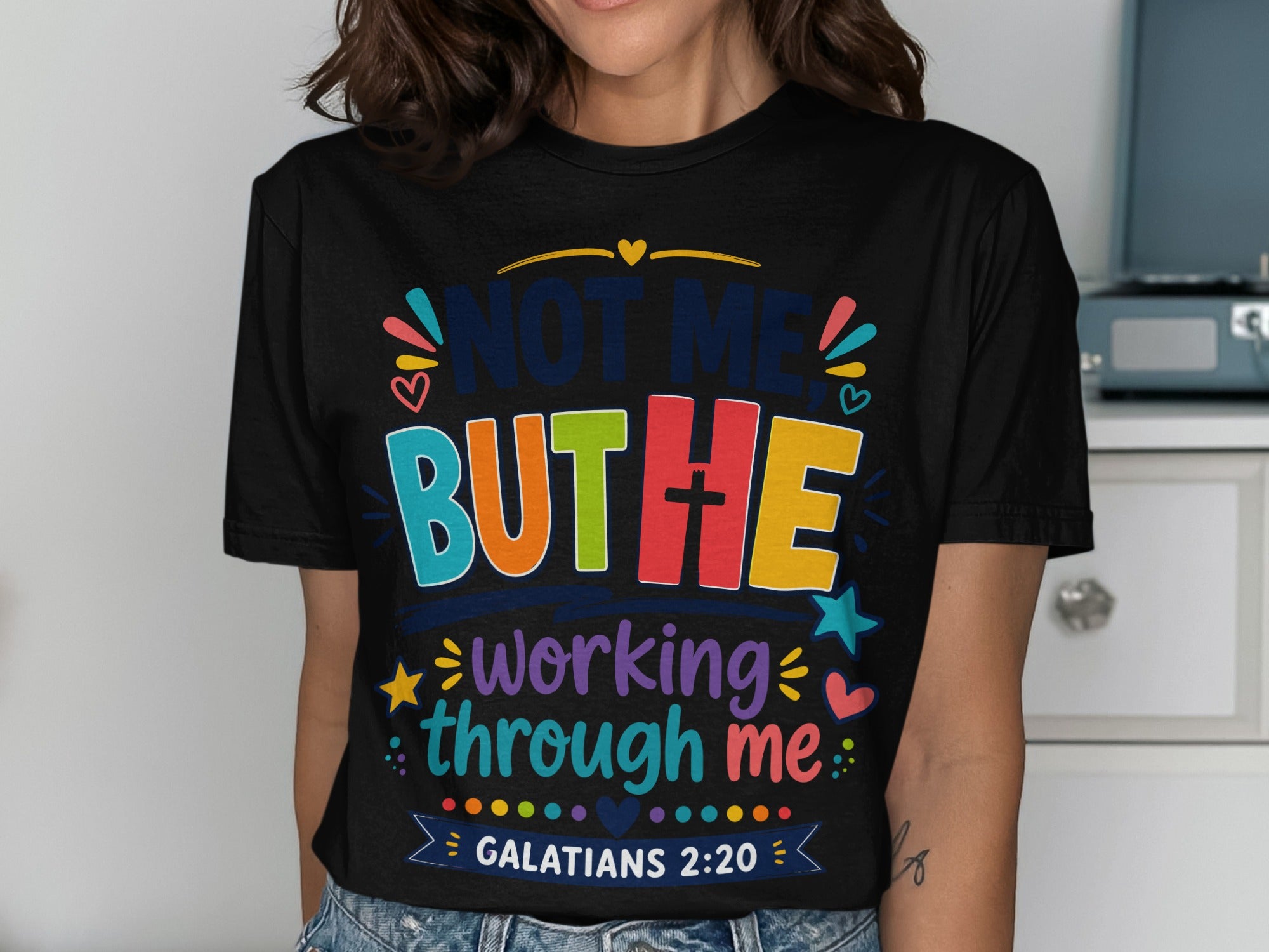 Black t-shirt with "Not me but He" and "working through me" text, Galatians 2:20.