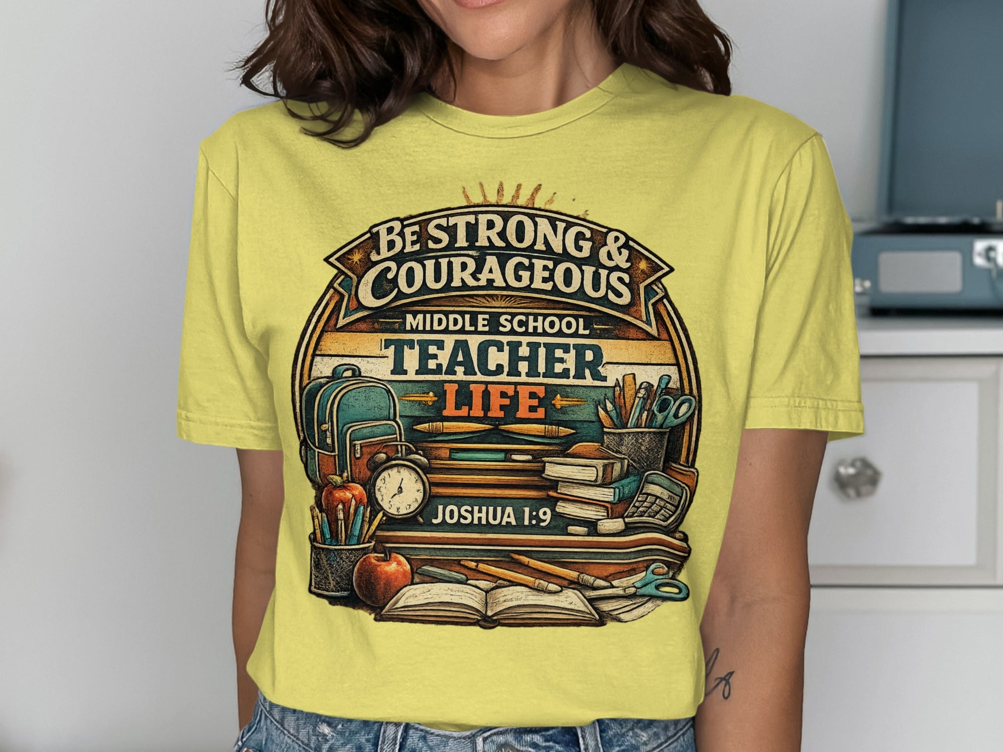 Yellow t-shirt with "Be Strong & Courageous Middle School Teacher Life" text and school supplies.