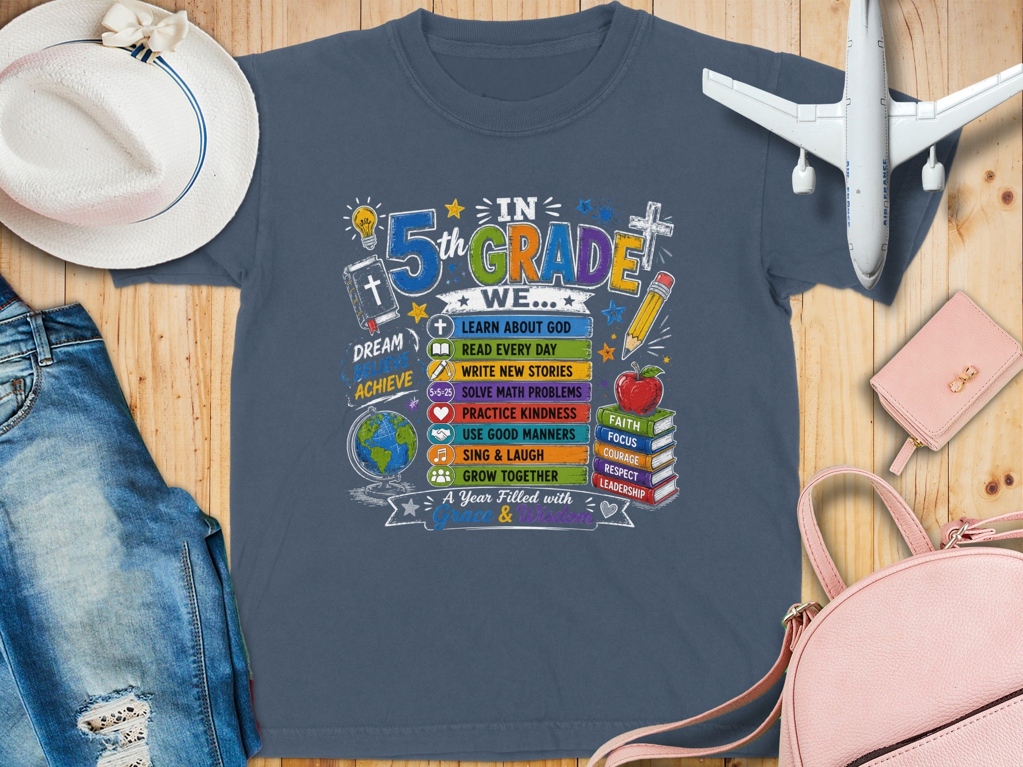 T-shirt with "5th GRADE WE..." text, school-themed icons, and motivational words.