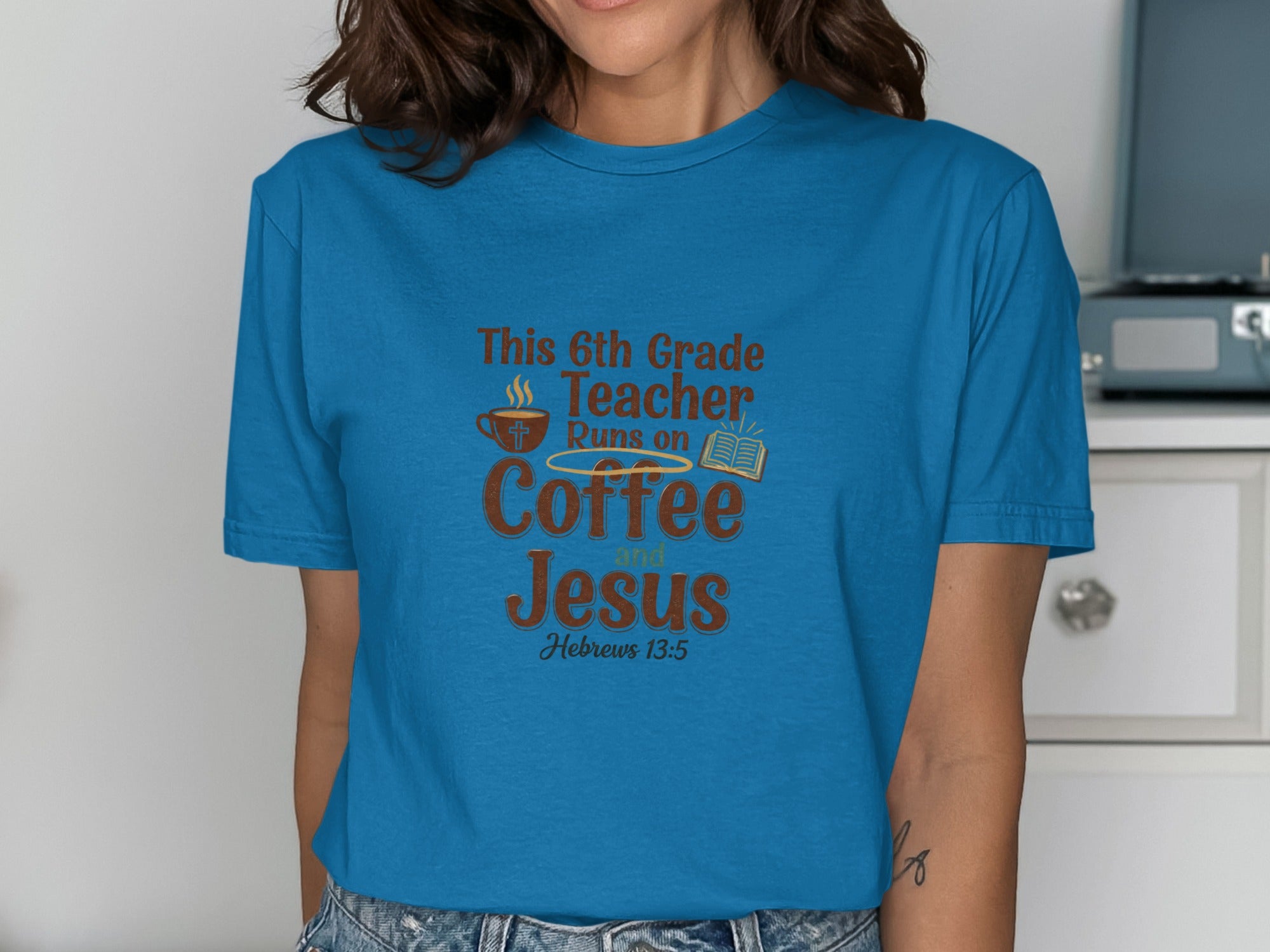Blue t-shirt with text "This 6th Grade Teacher Runs on Coffee and Jesus".