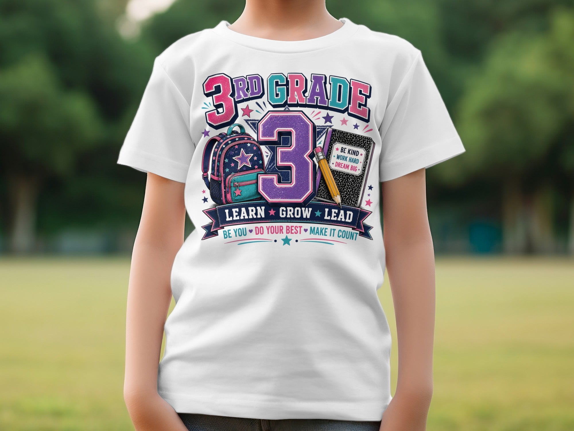 White t-shirt with "3RD GRADE LEARN GROW LEAD" and school supplies graphic.