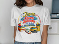 White t-shirt with "Jesus Loves Them...And So Do I" and school-themed illustration.
