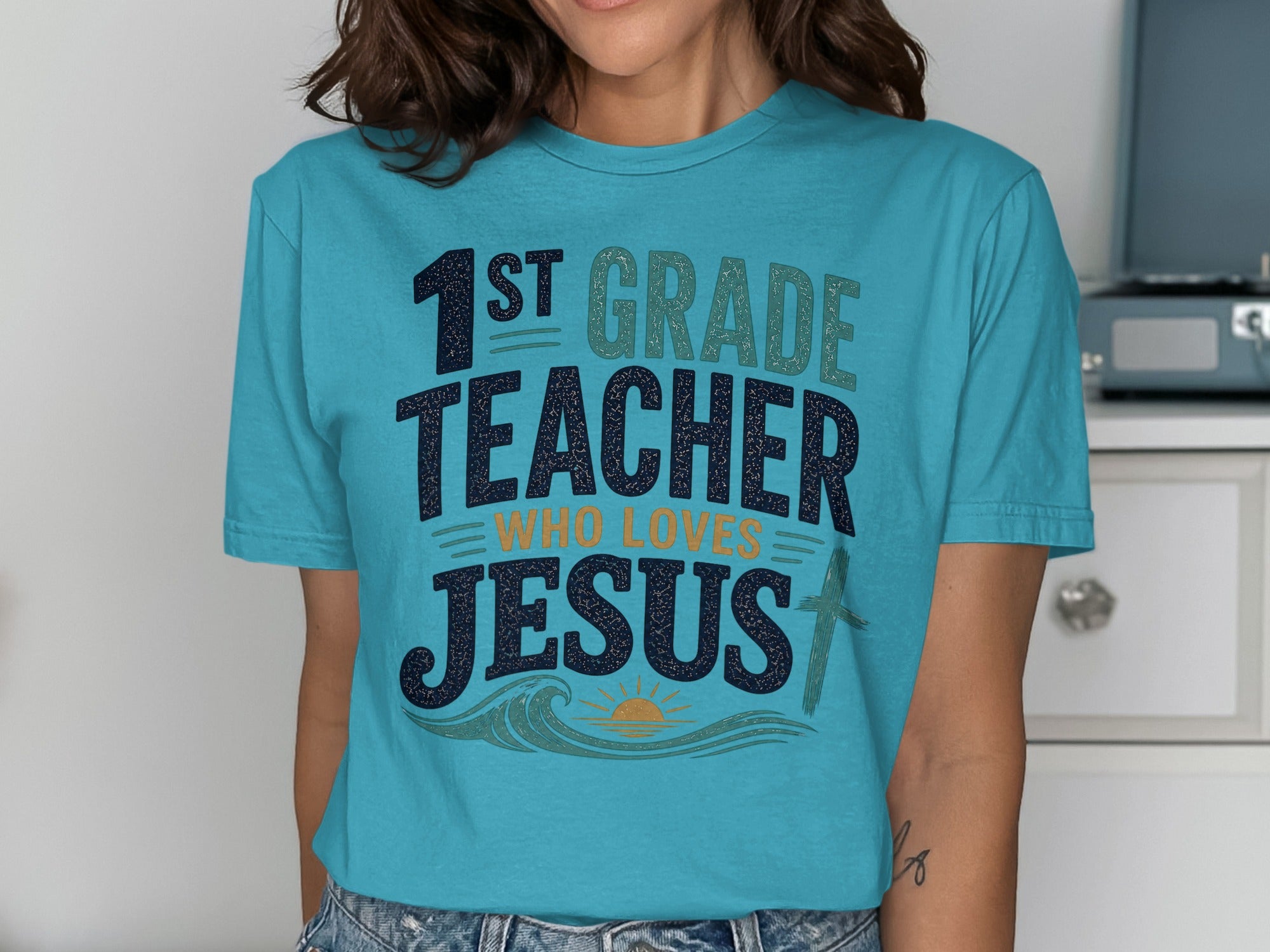 1st Grade Teacher who loves Jesus graphic t-shirt.