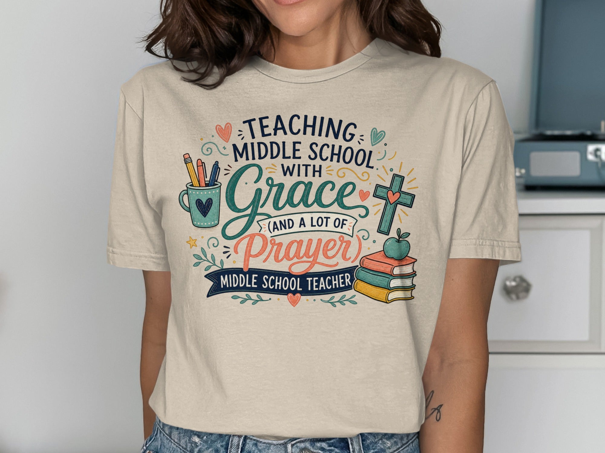 T-shirt with "Teaching Middle School with Grace and a lot of Prayer" and teacher graphics.