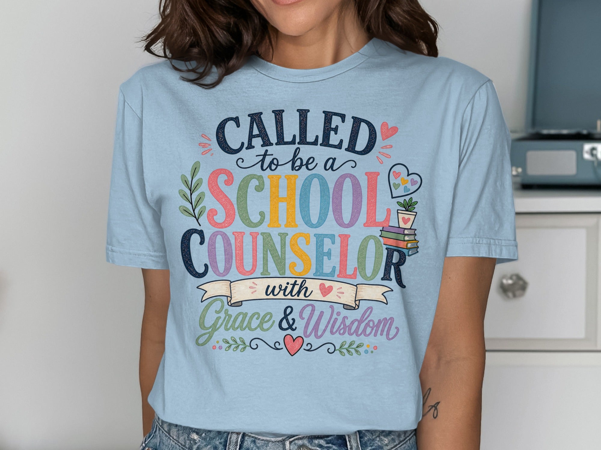 Light blue t-shirt with "Called to be a School Counselor with Grace & Wisdom" text.
