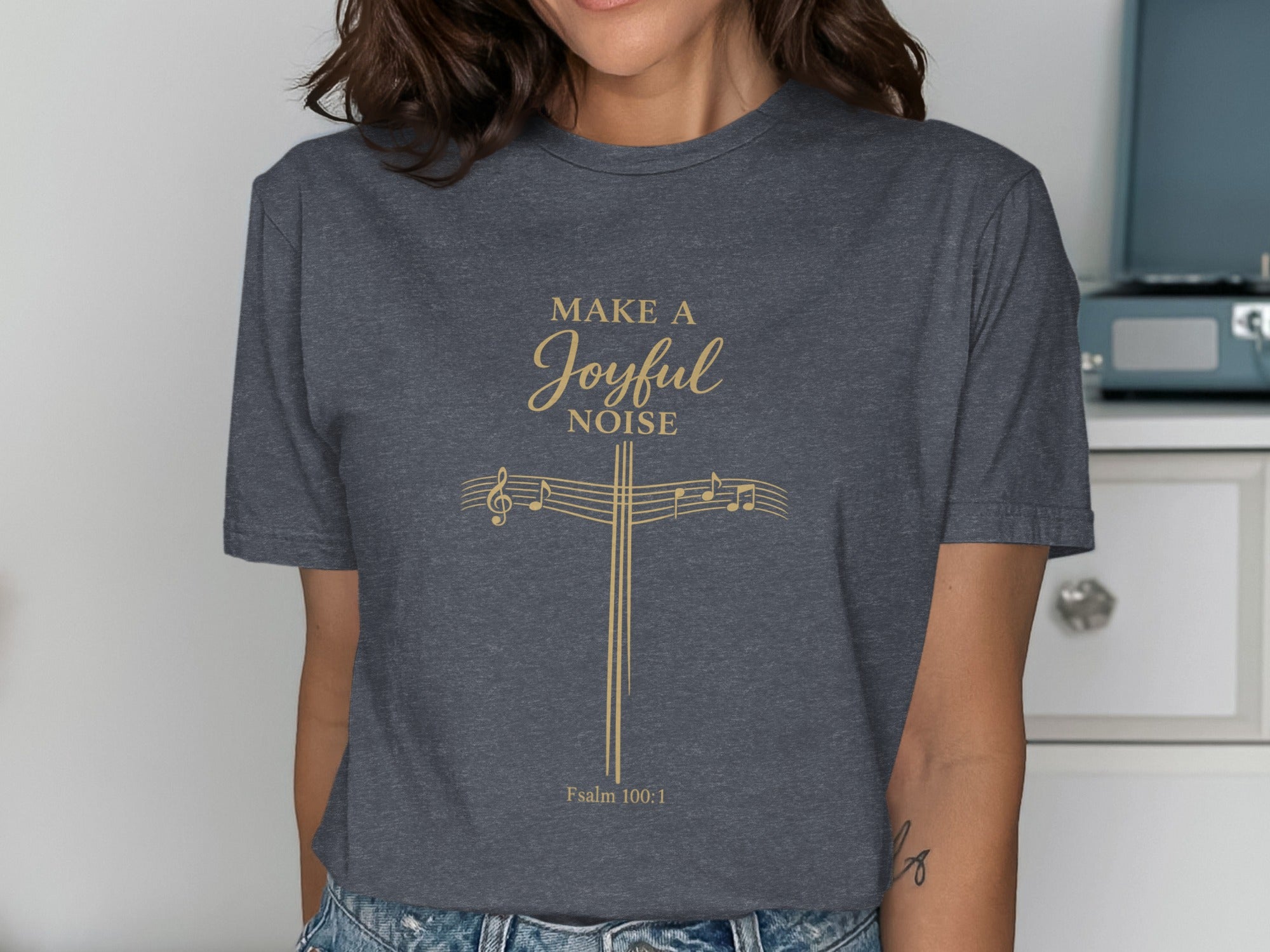 Dark grey t-shirt with gold cross, musical notes, and "Make a joyful noise Psalm 100:1".