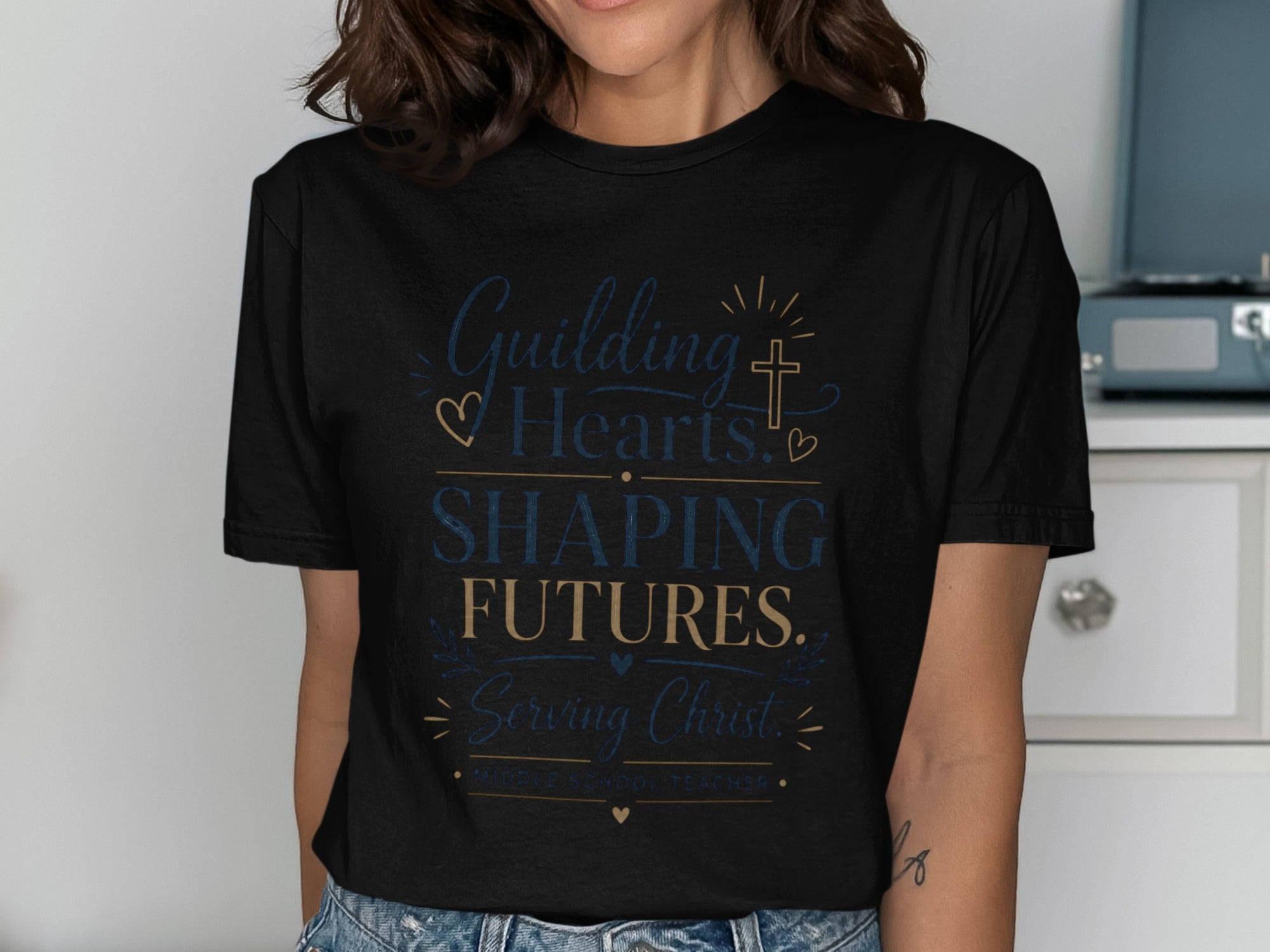 Black t-shirt with text "Guiding Hearts, Shaping Futures. Serving Christ. Middle School Teacher."