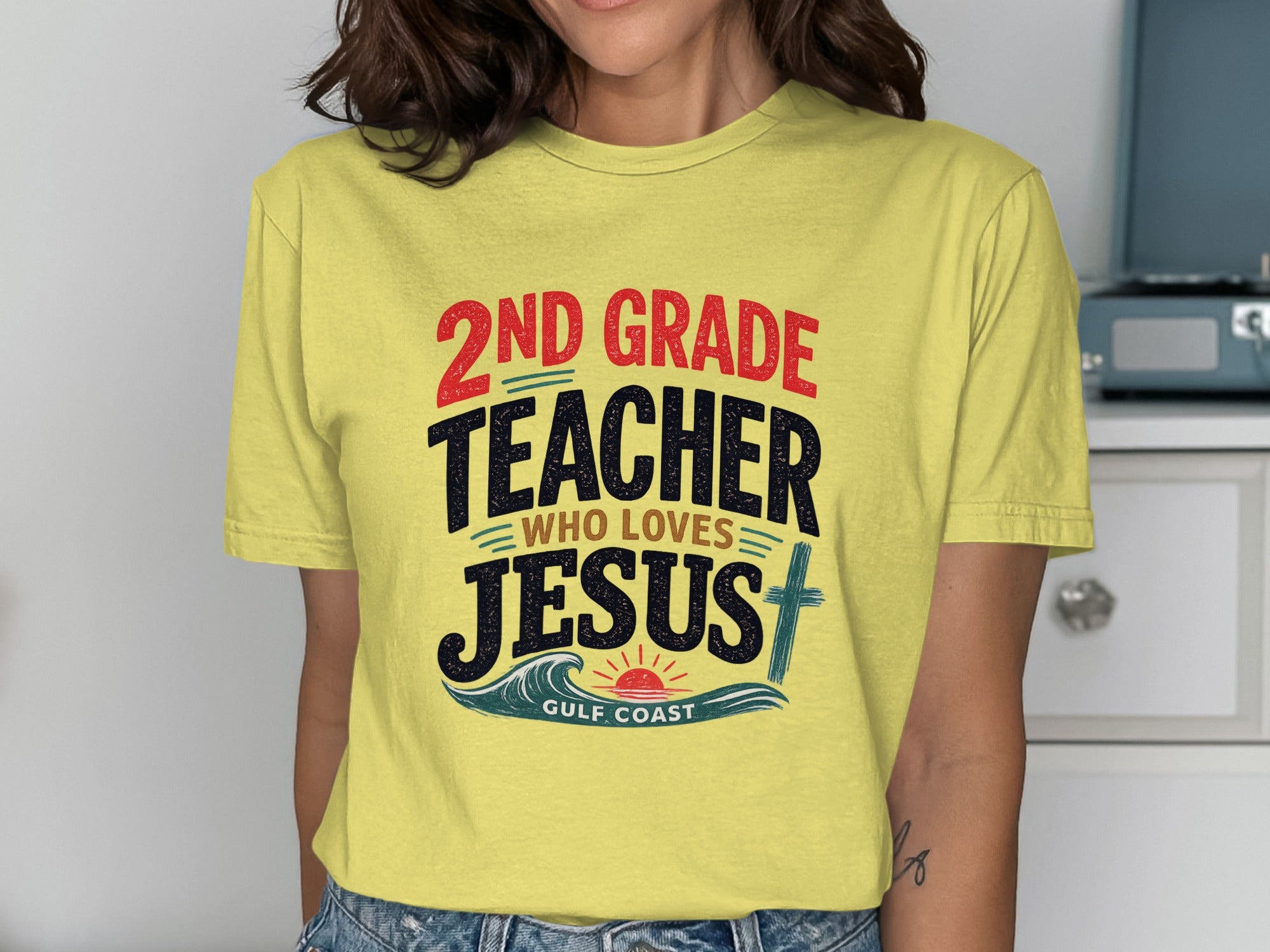 Yellow t-shirt with "2nd Grade Teacher Who Loves Jesus Gulf Coast" text.