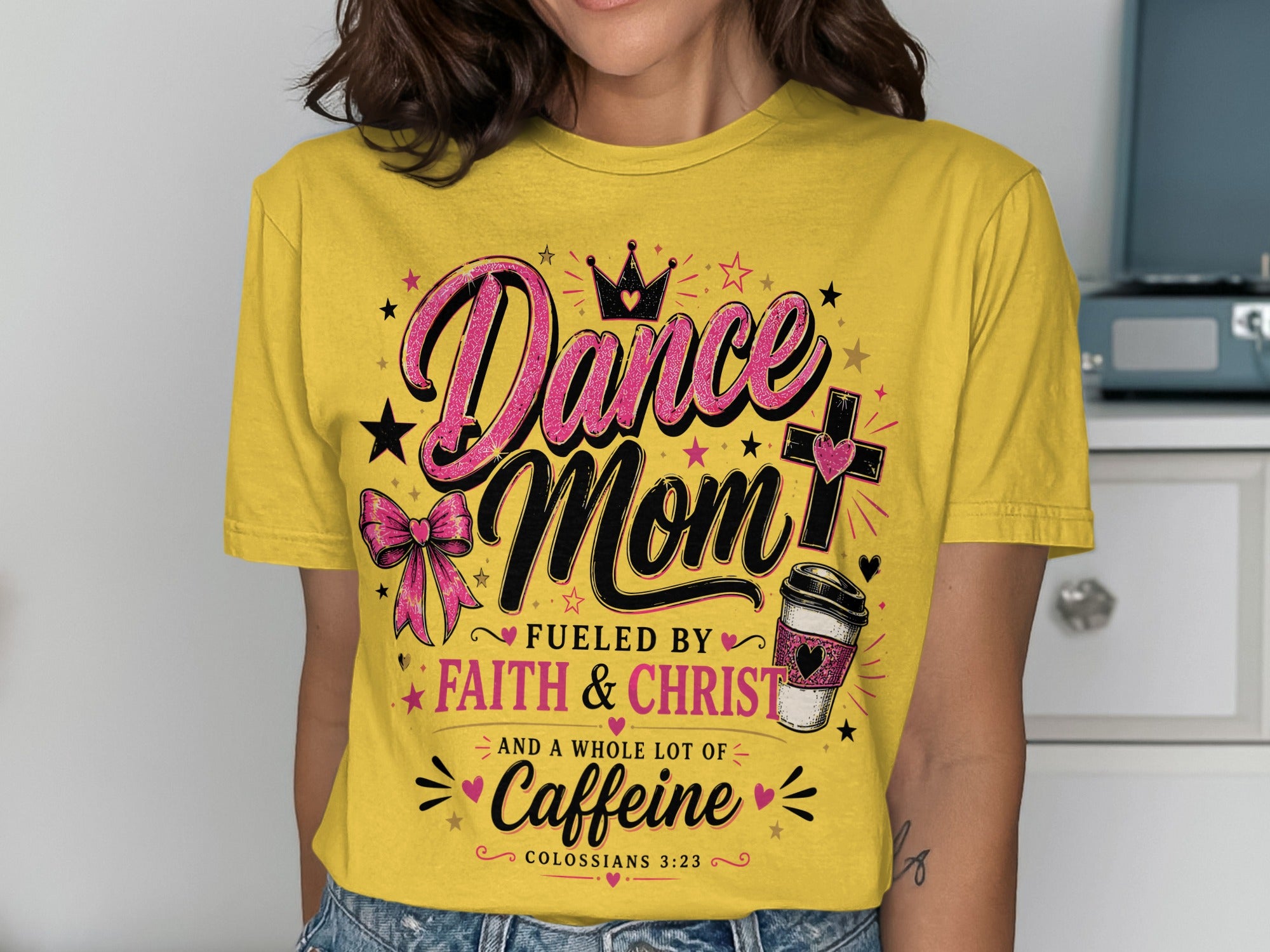Yellow t-shirt with "Dance Mom Fueled by Faith & Christ and a whole lot of Caffeine" text.