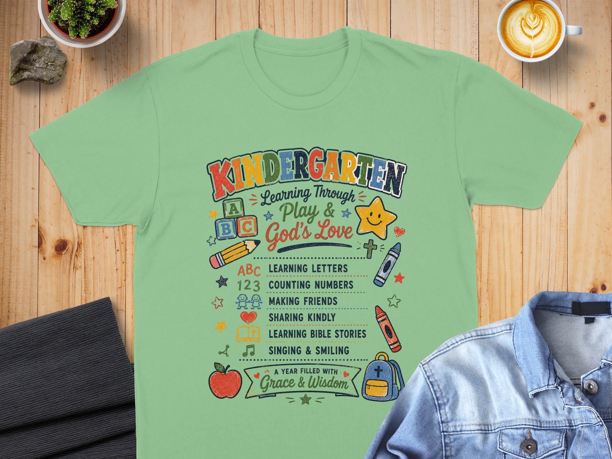 Kindergarten shirt with "Learning Through Play & God's Love" and learning icons.