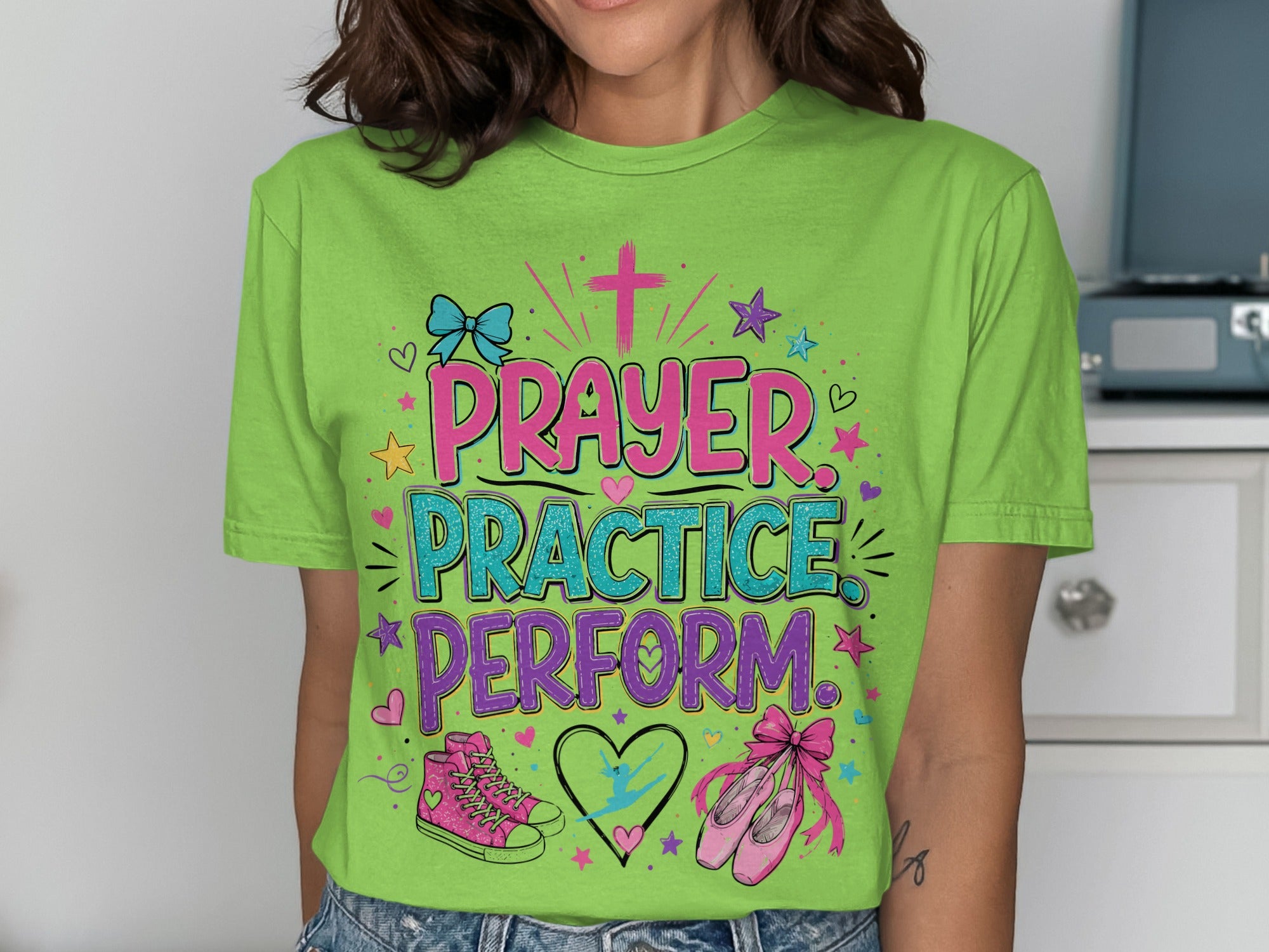 Green t-shirt with "Prayer Practice Perform" text and ballet shoes graphic.