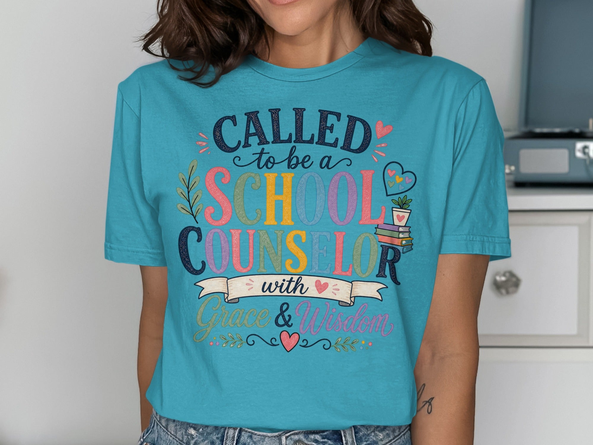 "Called to be a School Counselor with Grace & Wisdom" text on a turquoise t-shirt.