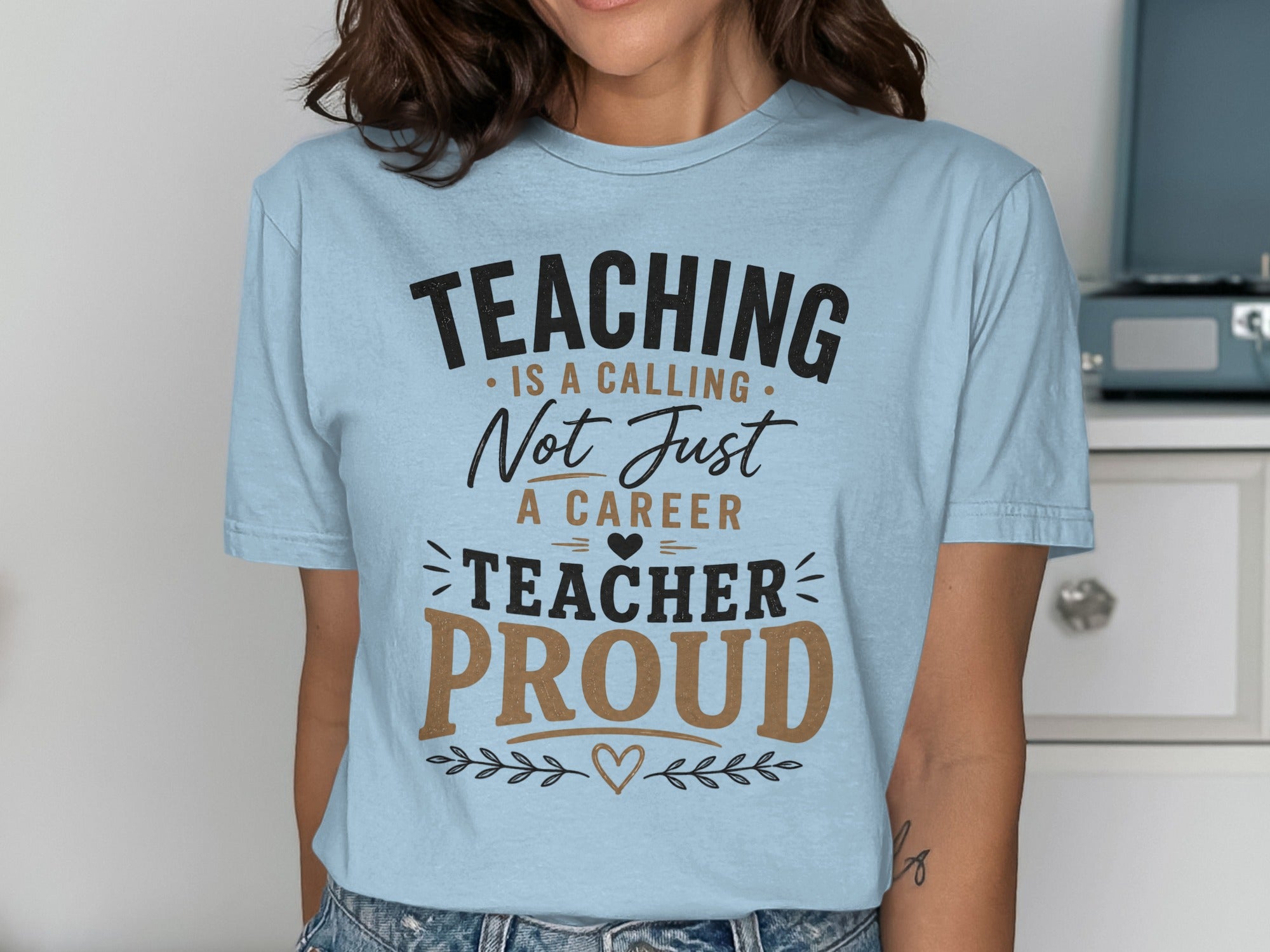 Light blue t-shirt with "Teaching is a calling, not just a career. Teacher proud."