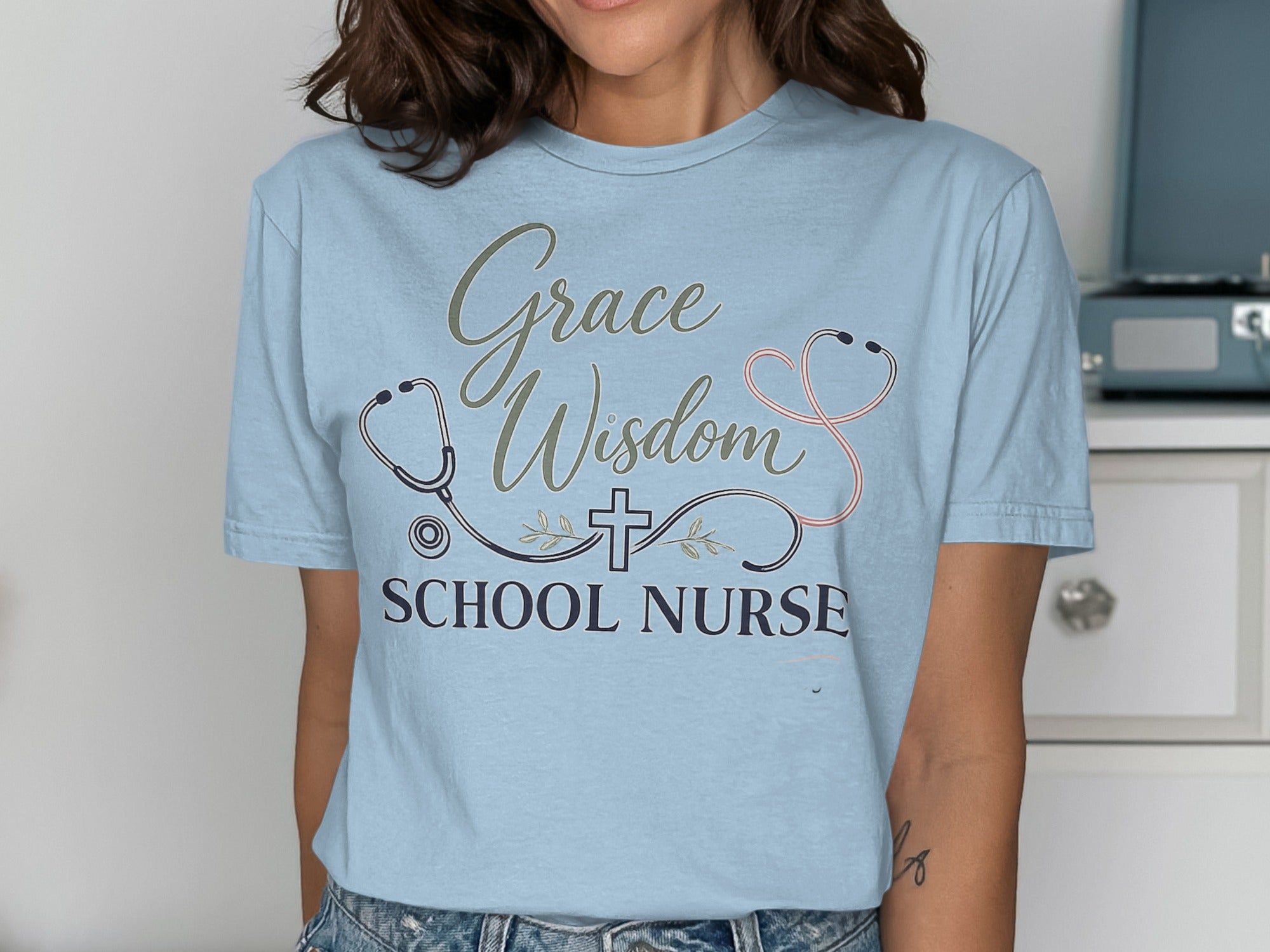 Light blue t-shirt with "Grace Wisdom School Nurse" and stethoscope design.