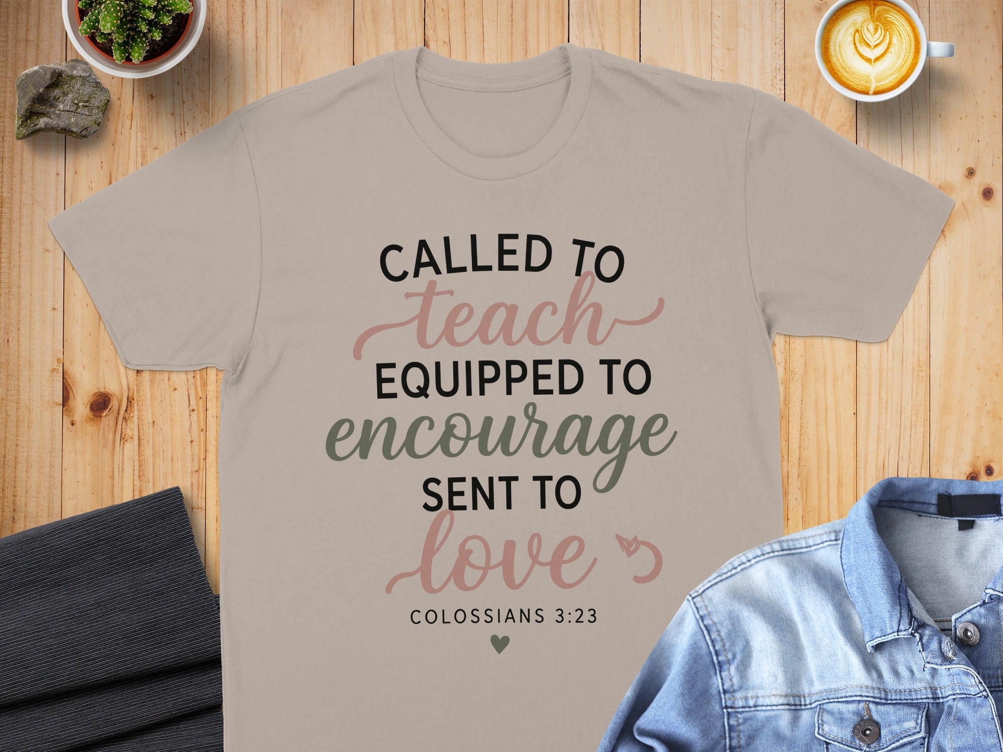 T-shirt with "Called to Teach, Equipped to Encourage, Sent to Love" text.