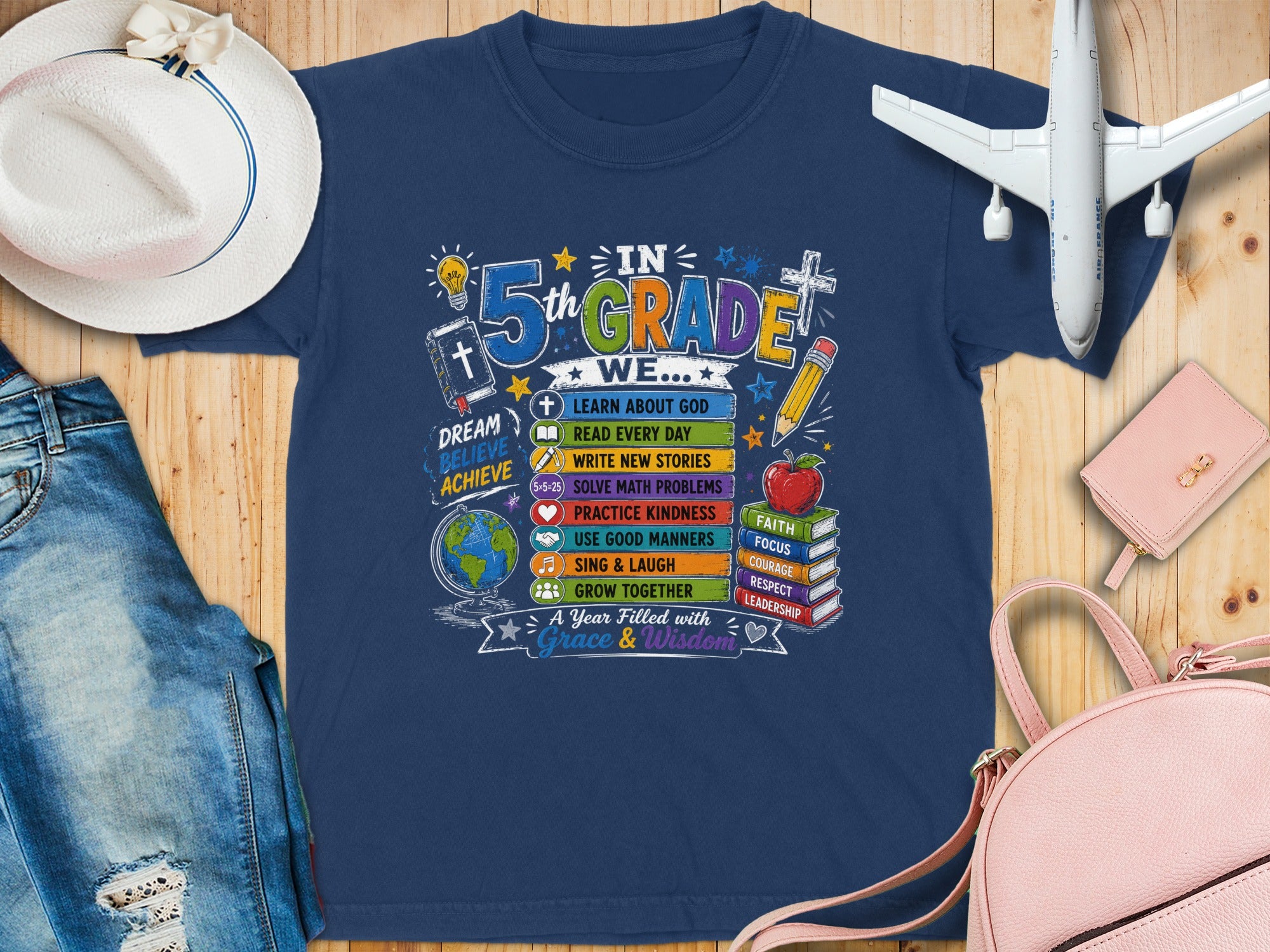 Navy t-shirt with "5th Grade" and school-themed graphics.