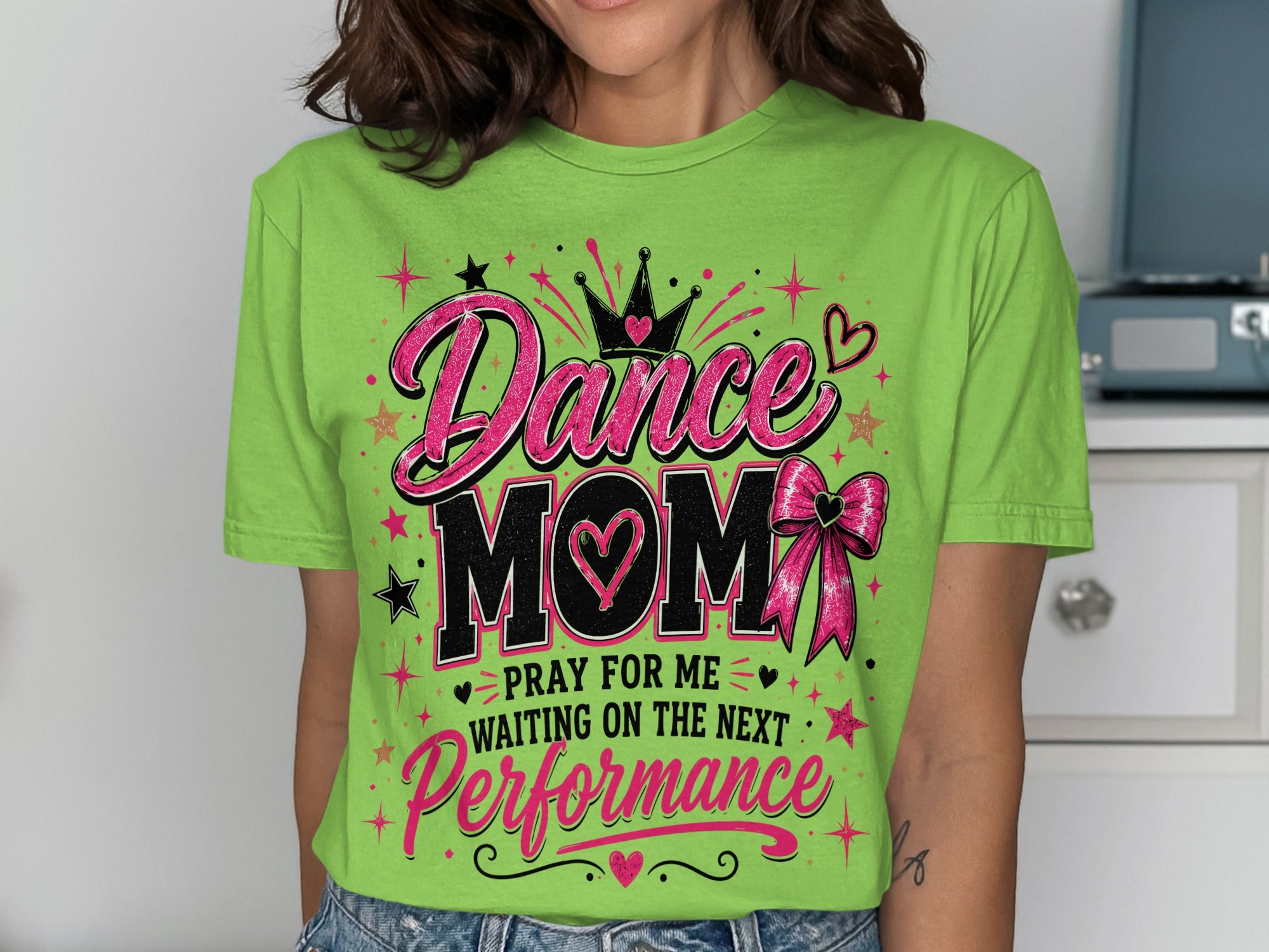 Green t-shirt with "Dance Mom" crown, hearts, bow, and performance text.