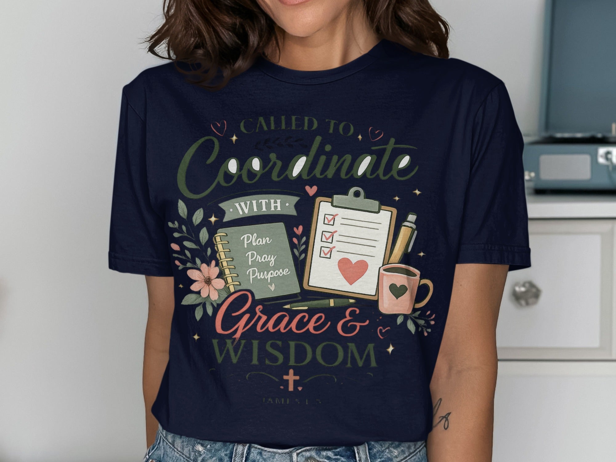 Navy t-shirt with "Called to Coordinate with Grace & Wisdom" text and floral design.