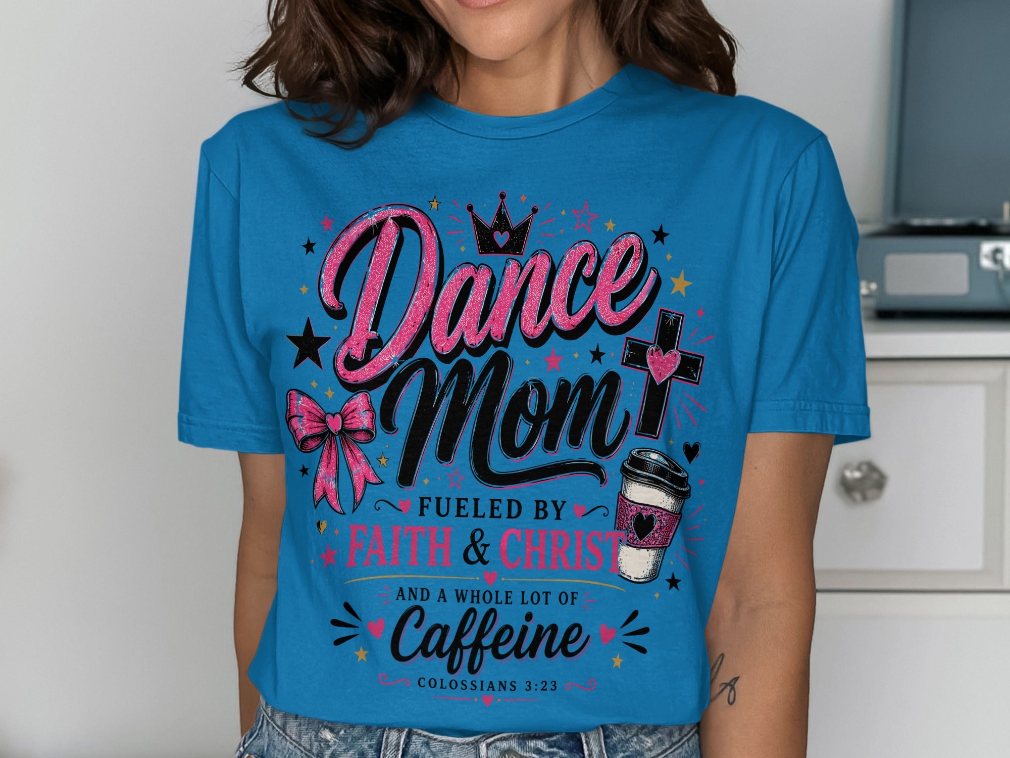 Blue t-shirt with "Dance Mom Fueled by Faith & Christ and a whole lot of Caffeine" text.