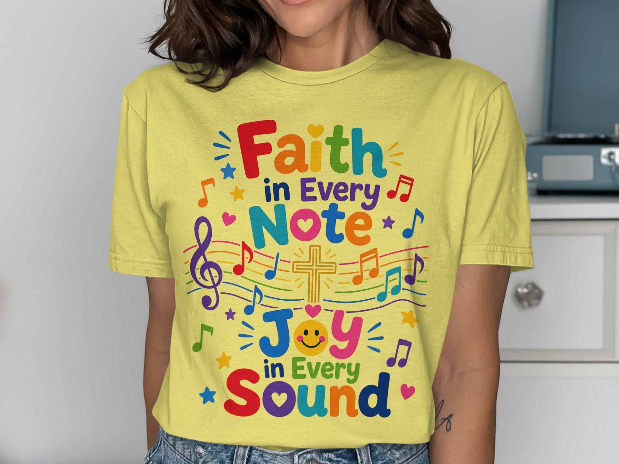 Yellow t-shirt with "Faith in Every Note, Joy in Every Sound" and musical notes.
