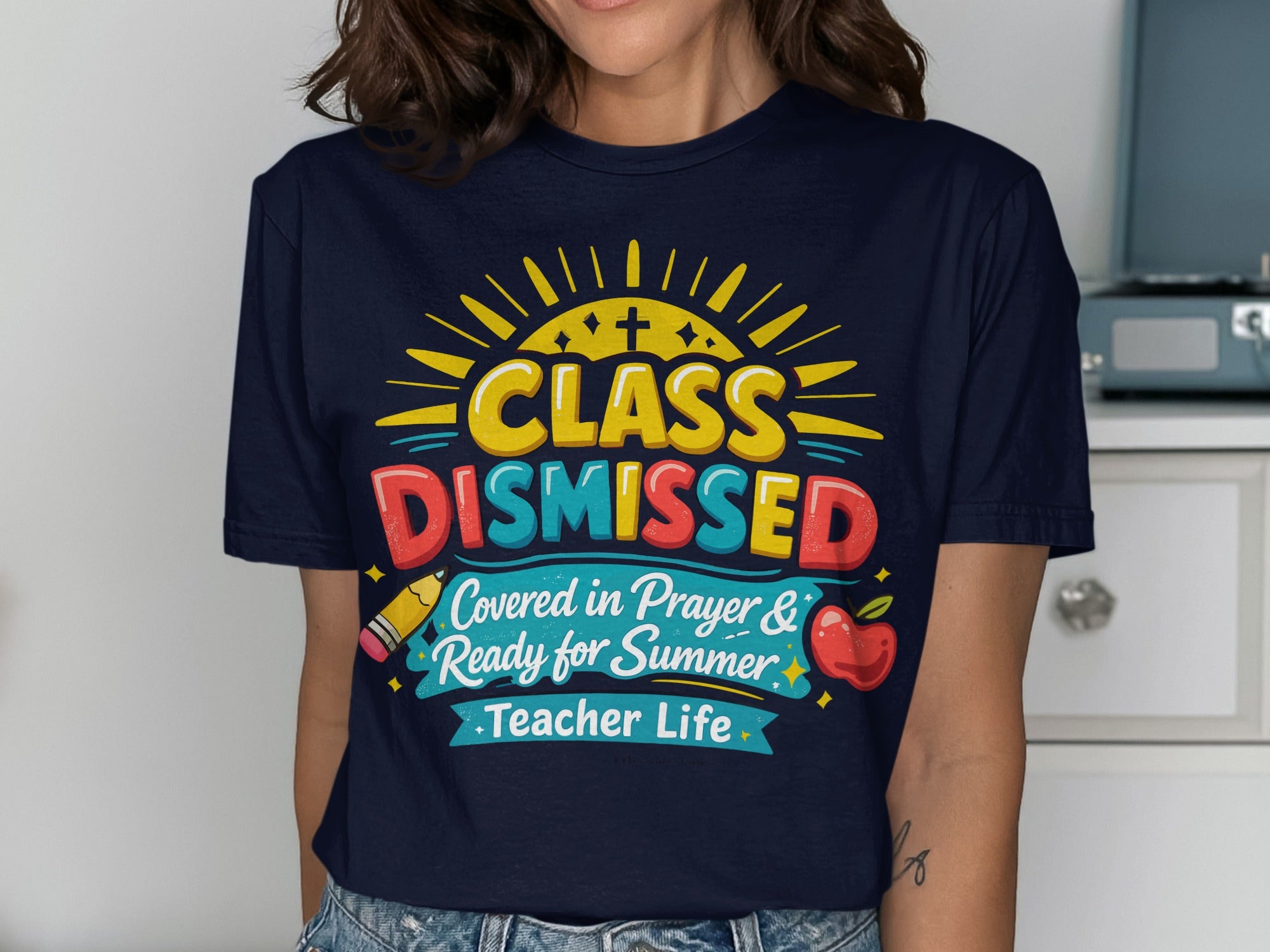 Navy t-shirt with "Class Dismissed" in colorful lettering, teacher life theme.