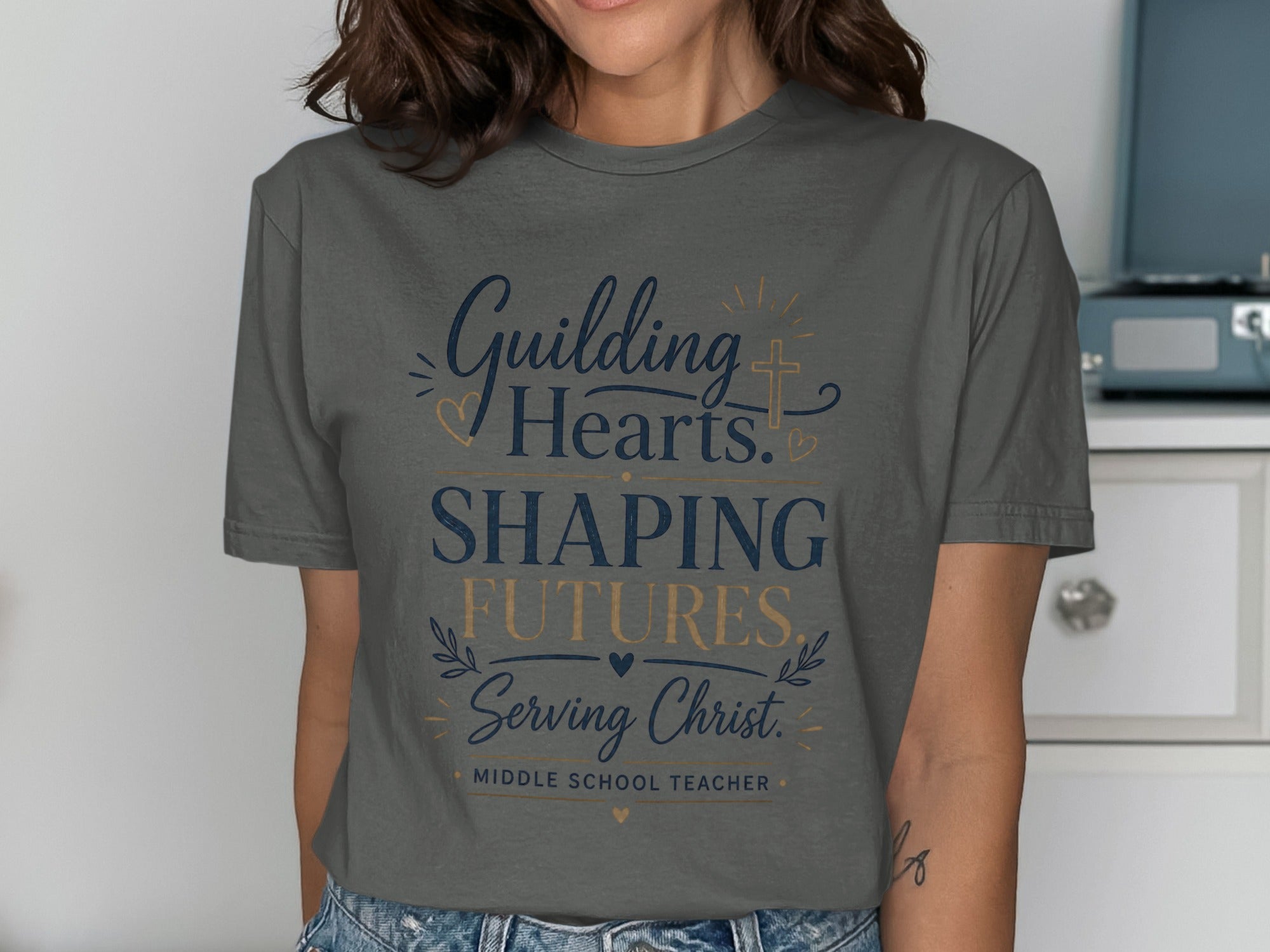 T-shirt with "Guiding Hearts, Shaping Futures, Serving Christ. Middle School Teacher." text.