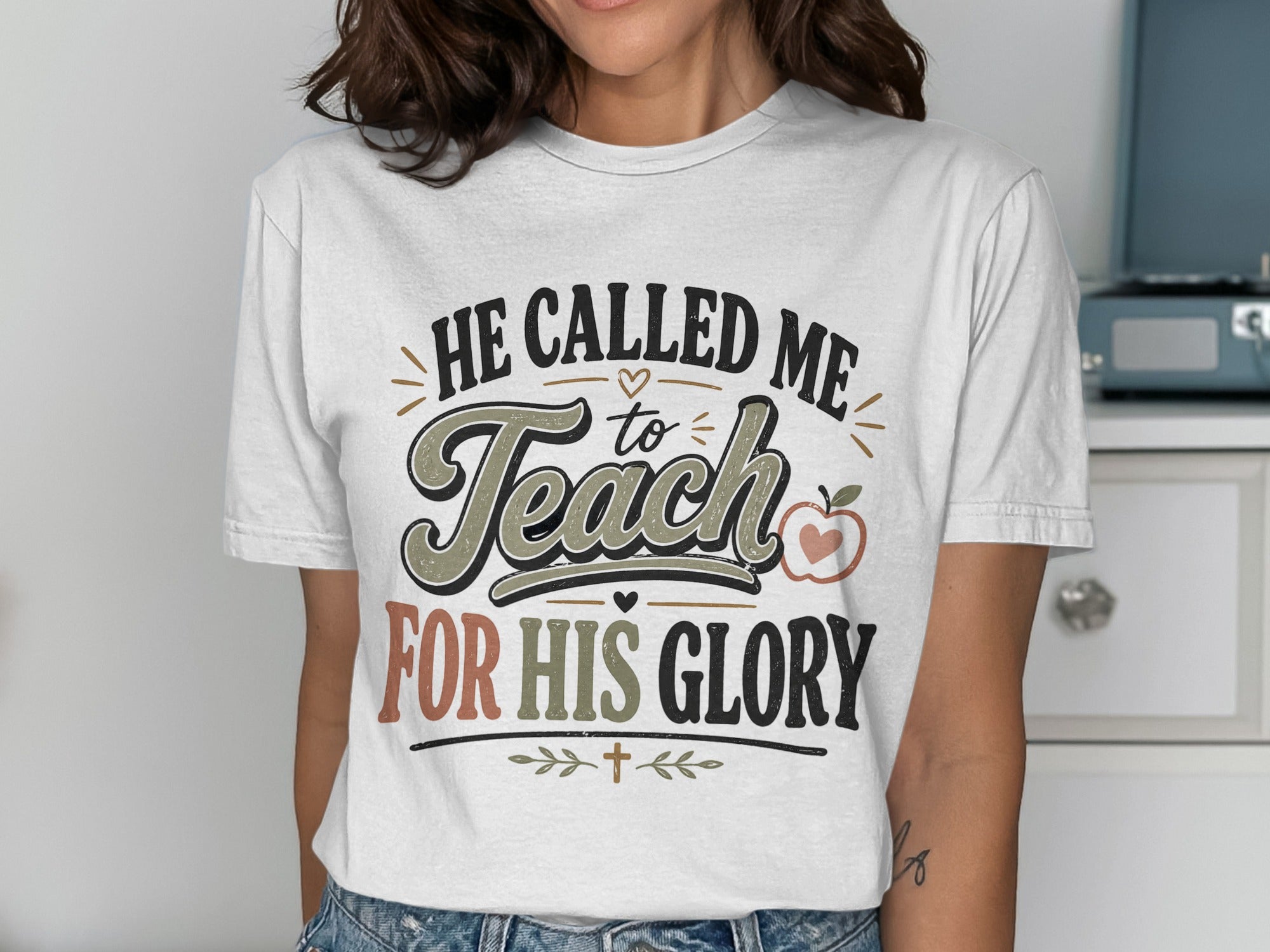 White t-shirt with "He Called Me to Teach For His Glory" text and apple graphic.