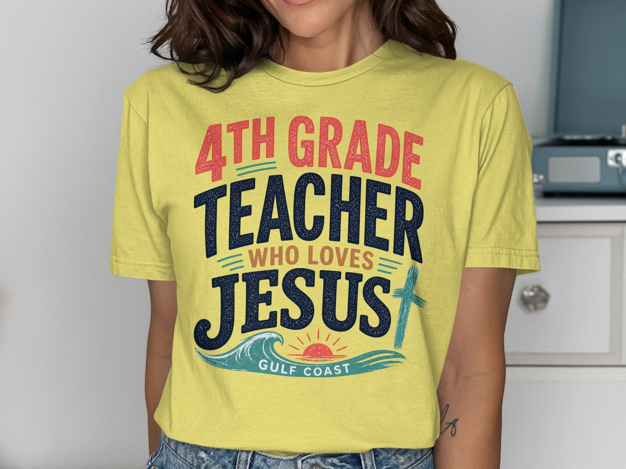 Yellow t-shirt with text: 4th Grade Teacher Who Loves Jesus, Gulf Coast.