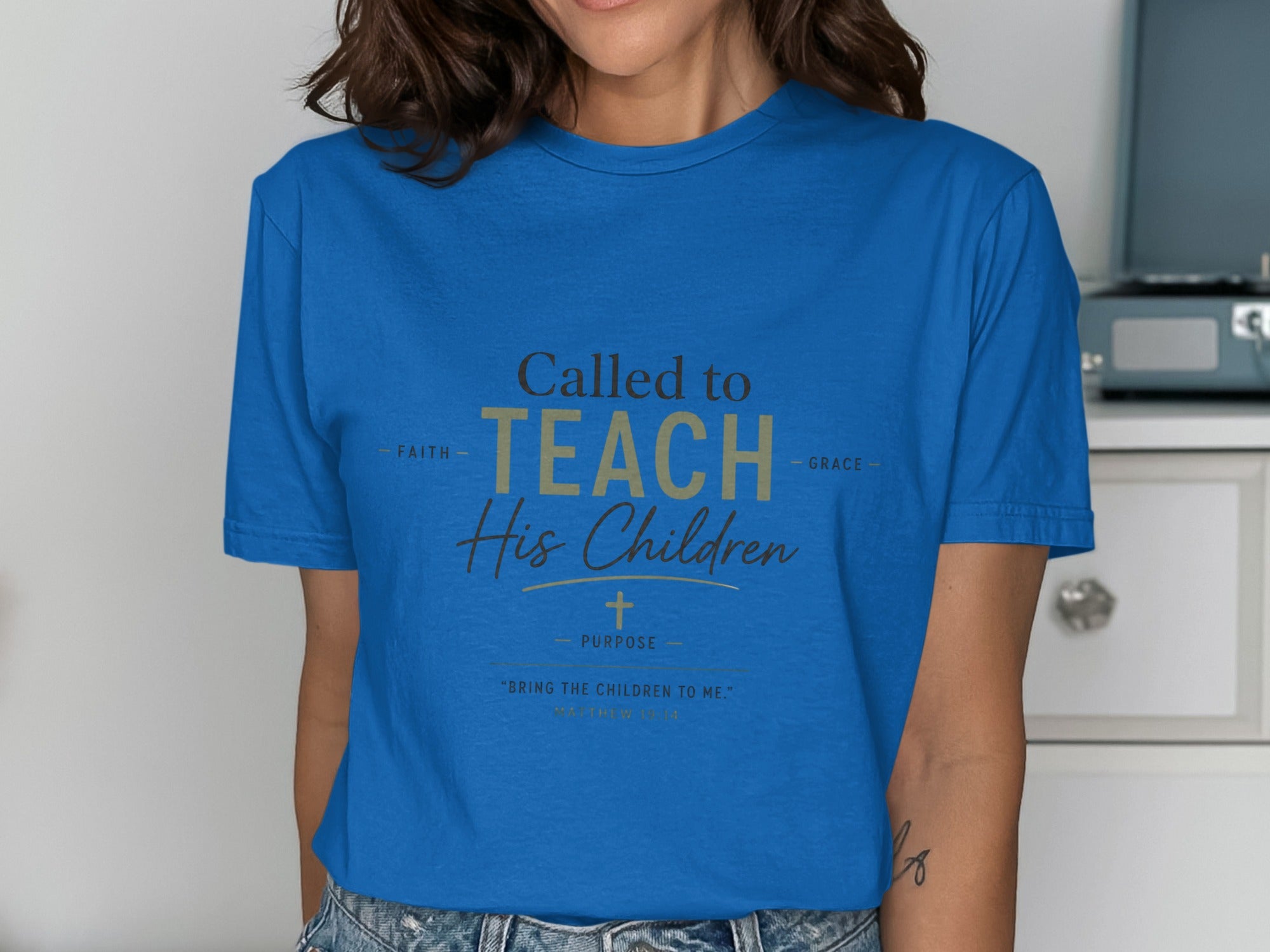 Royal blue t-shirt with gold text: "Called to TEACH His Children, FAITH GRACE PURPOSE, 'BRING THE CHILDREN TO ME.'"