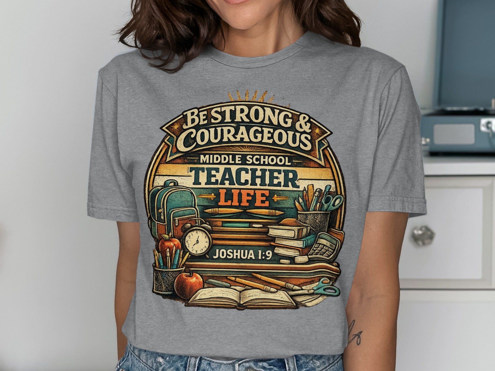 Be Strong & Courageous Middle School Teacher Life t-shirt with books and school supplies.