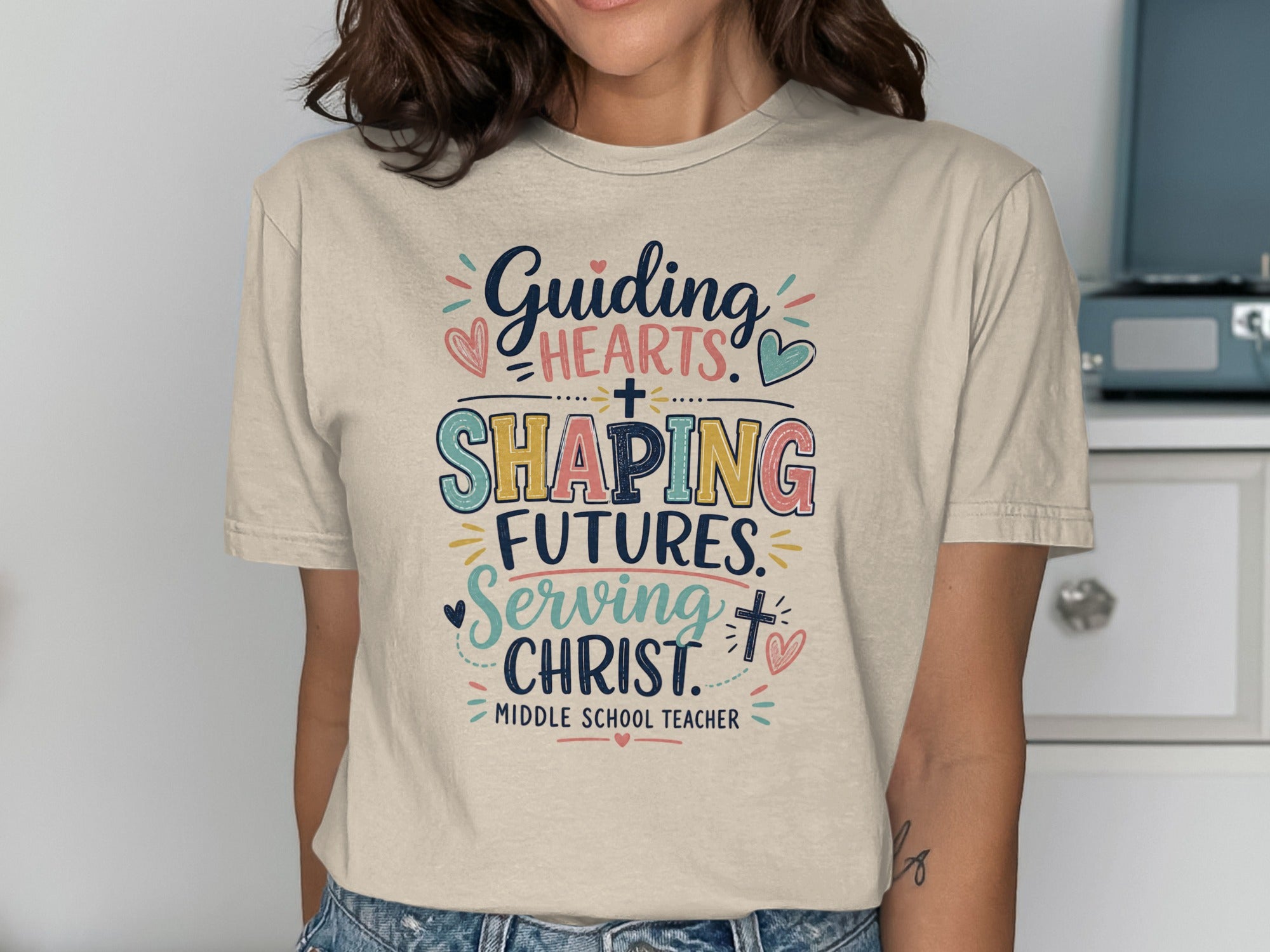 T-shirt with text "Guiding Hearts, Shaping Futures, Serving Christ" Middle School Teacher.