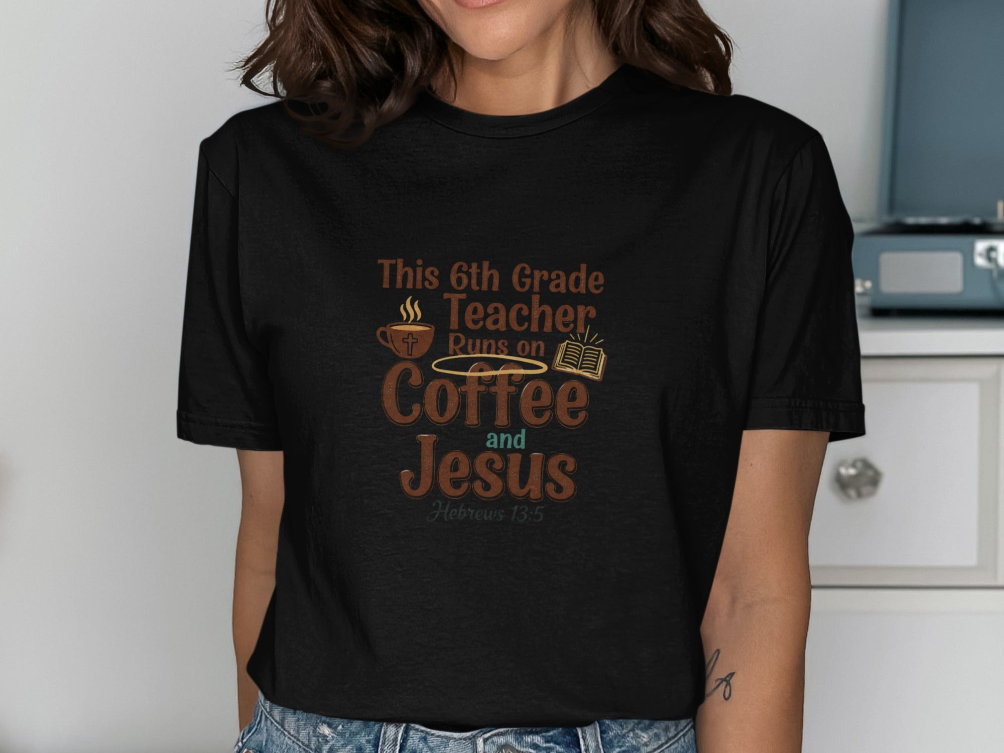 Black t-shirt with "This 6th Grade Teacher Runs on Coffee and Jesus" text.