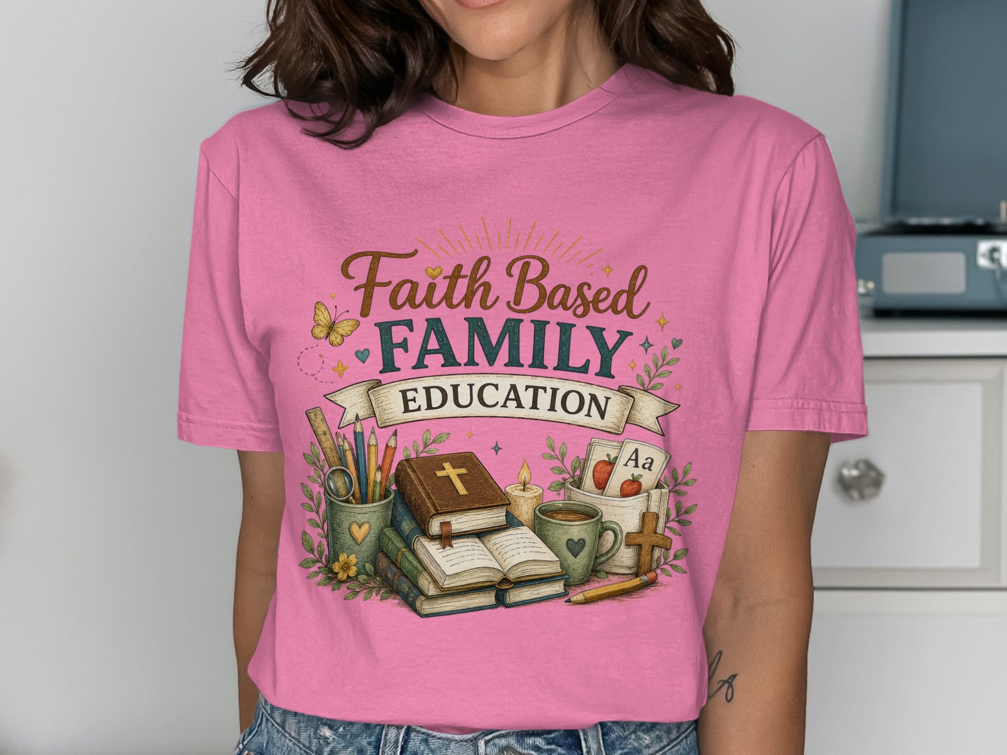 Faith Family Education shirt with books, candle, cross, and ABC cards.