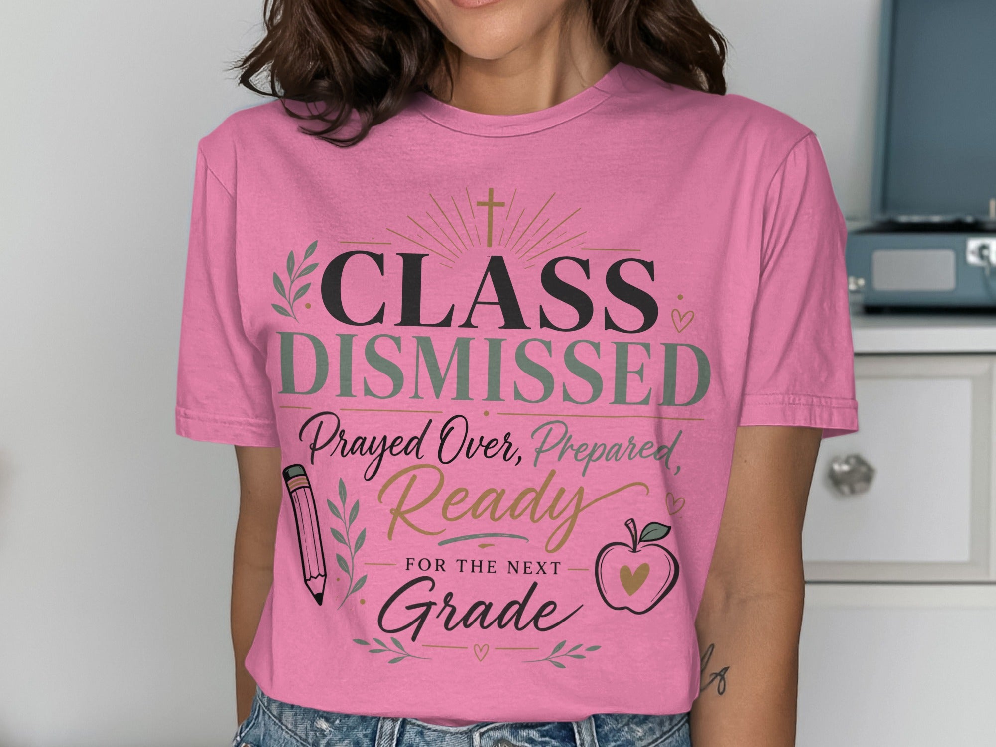 Pink t-shirt with "CLASS DISMISSED" and school-themed graphics.