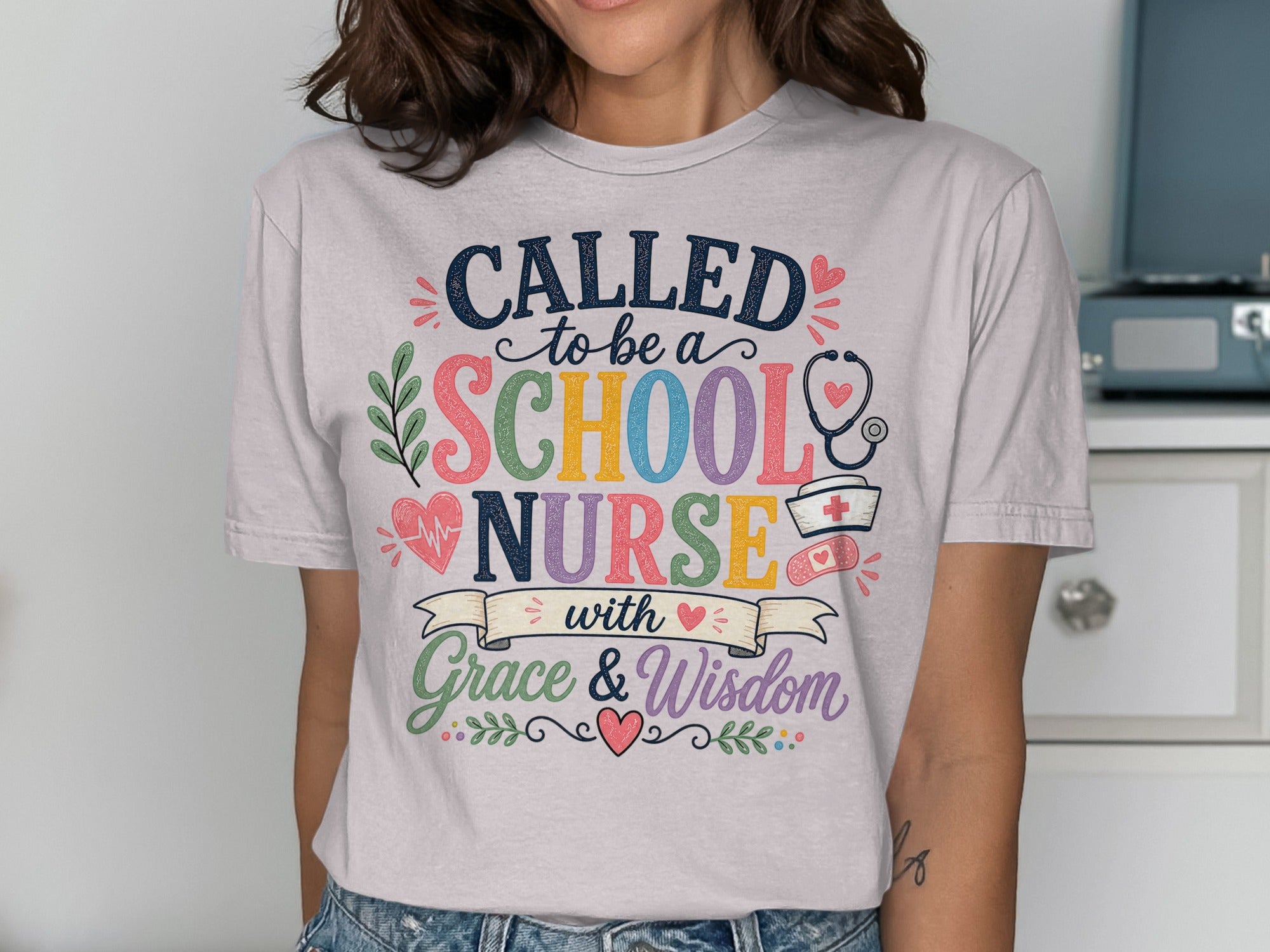 T-shirt with "Called to be a School Nurse with Grace & Wisdom" text and medical icons.