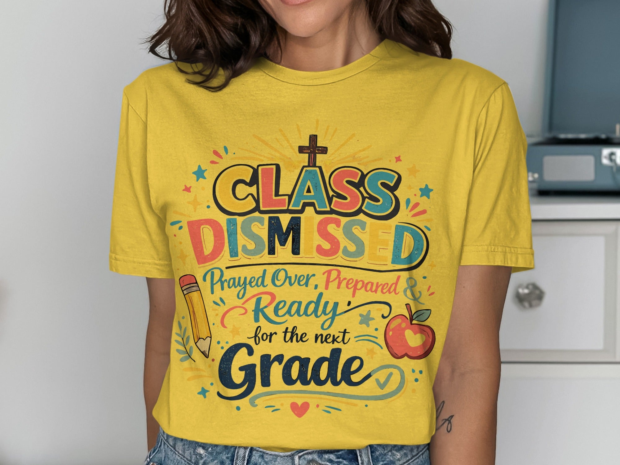 Yellow t-shirt with "Class Dismissed" text and school-themed graphics.