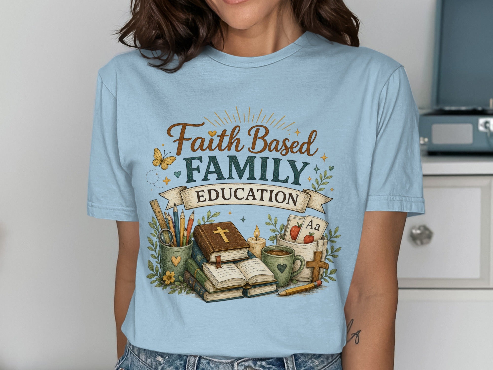 Light blue t-shirt with "Faith Family Education" text and school-related imagery.