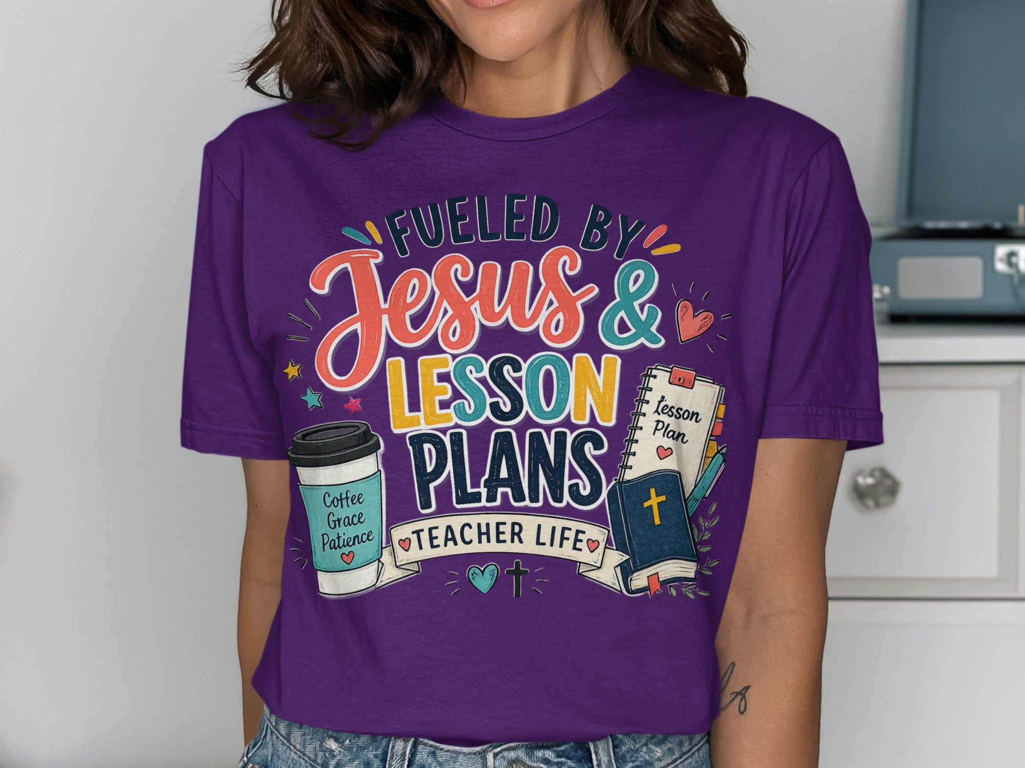 Purple t-shirt with "Fueled by Jesus & Lesson Plans" and teacher-themed icons.