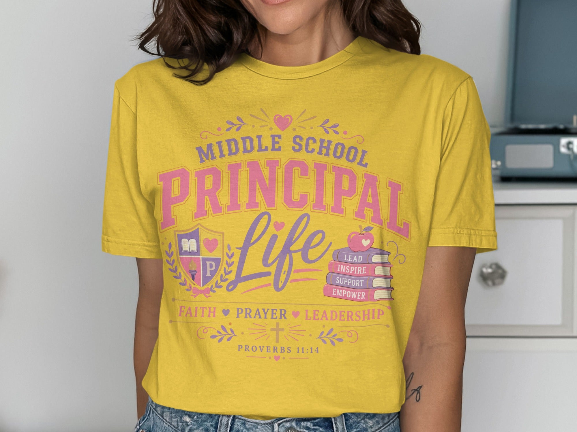 Yellow t-shirt with "Middle School Principal Life" text, books, and Proverbs 11:14.