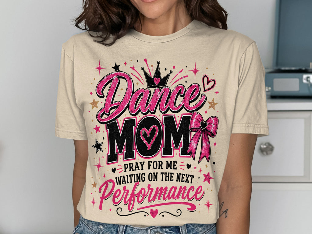Tan t-shirt with "Dance Mom" text, crown, heart, and bow graphics.