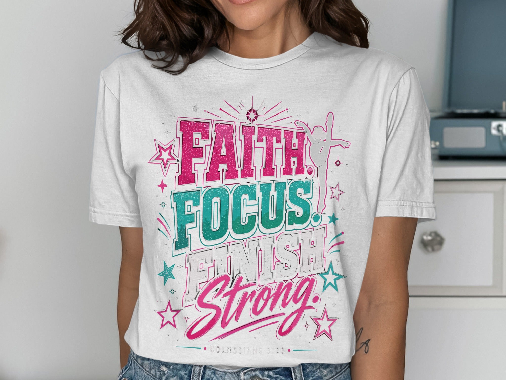 White t-shirt with "FAITH FOCUS FINISH Strong" text and star graphics.