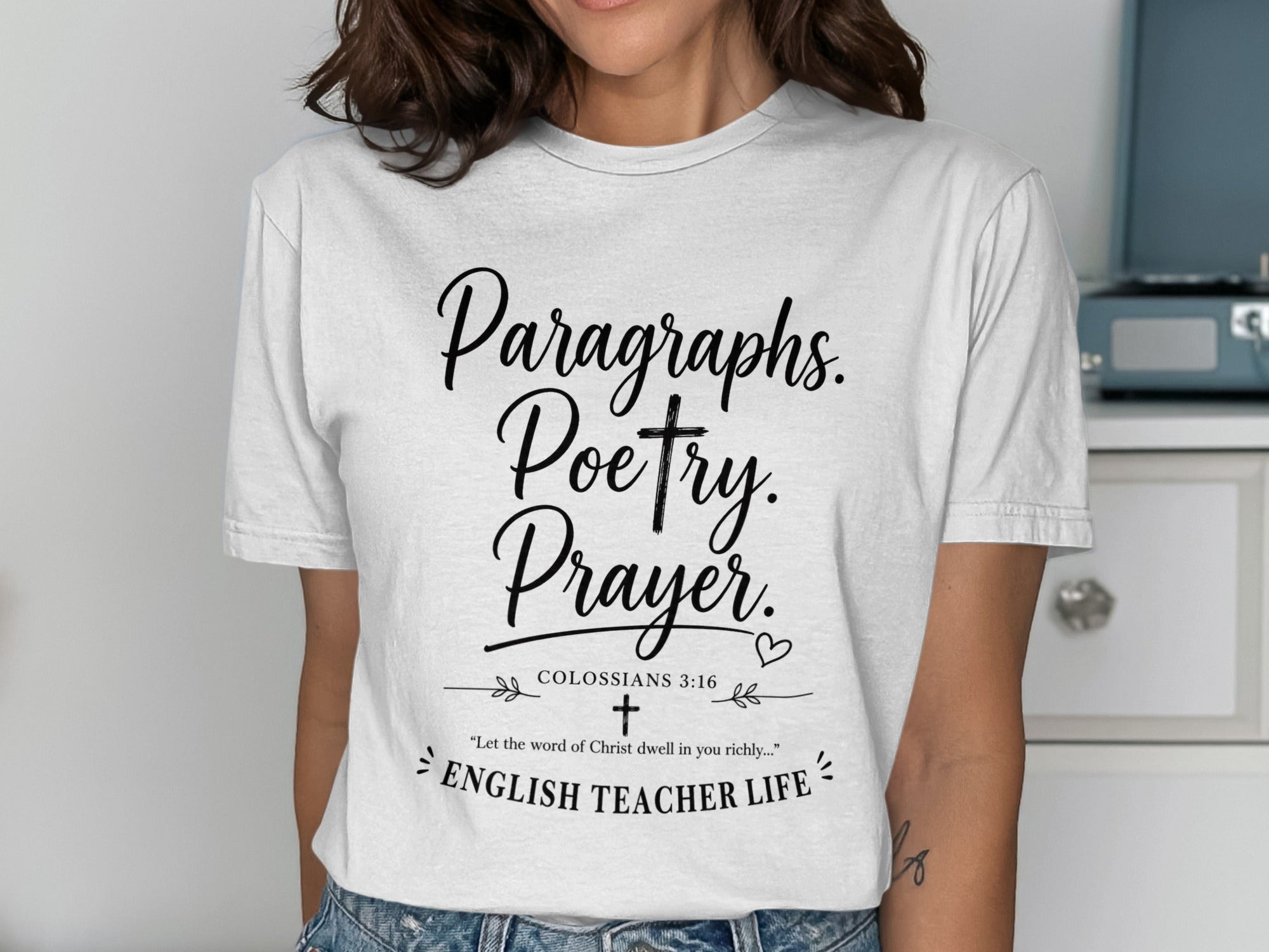 White t-shirt with "Paragraphs. Poetry. Prayer. English Teacher Life" text.