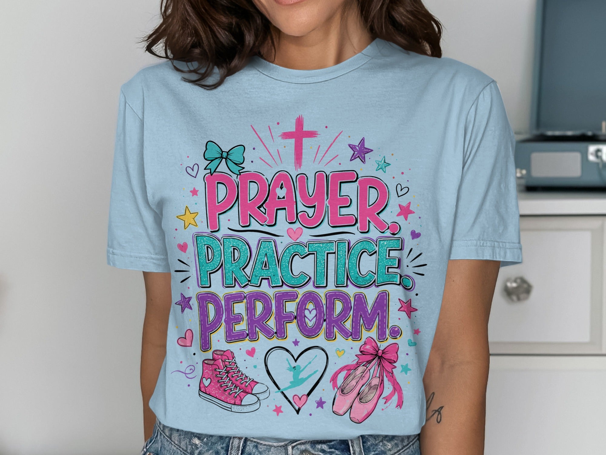 Light blue t-shirt with "Prayer Practice Perform" text and dance graphics.