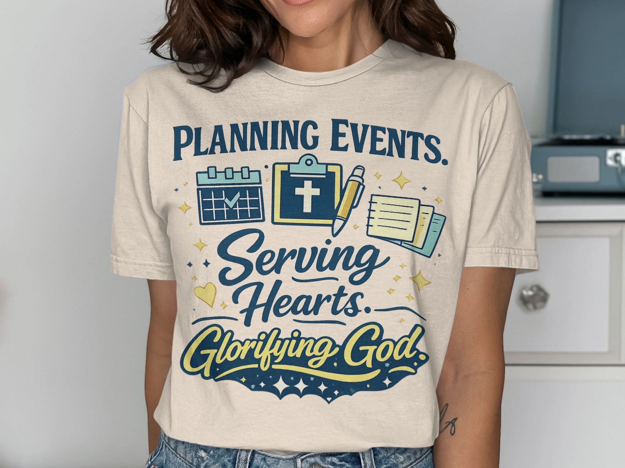 T-shirt with "Planning Events. Serving Hearts. Glorifying God." text and icons.