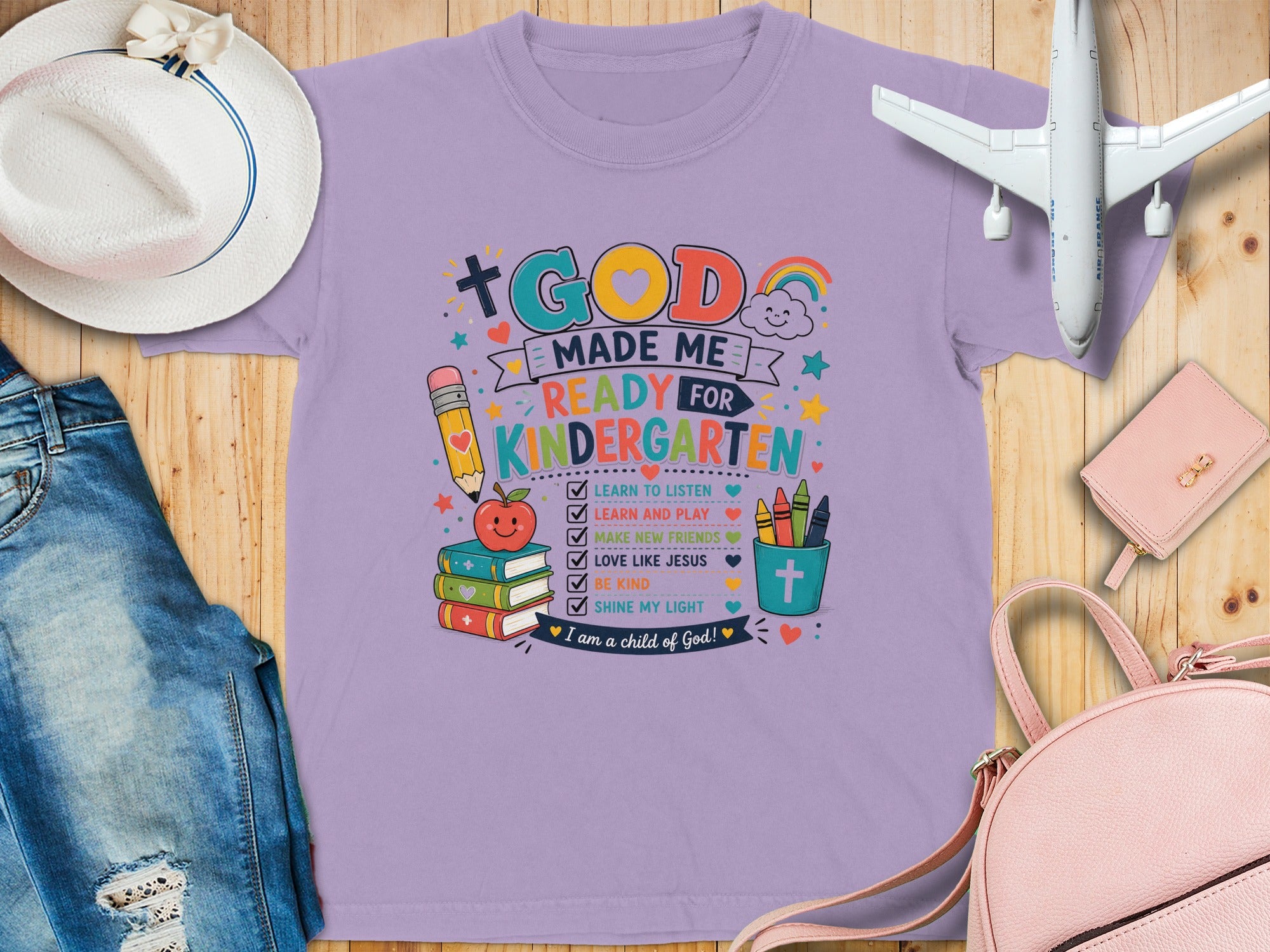 Purple t-shirt with "God Made Me Ready for Kindergarten" and classroom graphics.