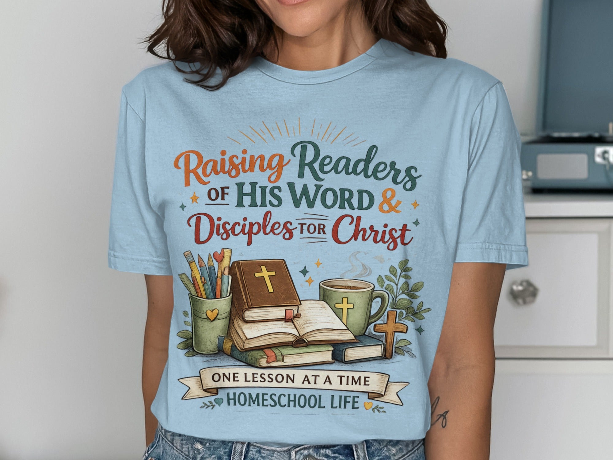 T-shirt with "Raising Readers of His Word & Disciples for Christ" and homeschooling graphics.